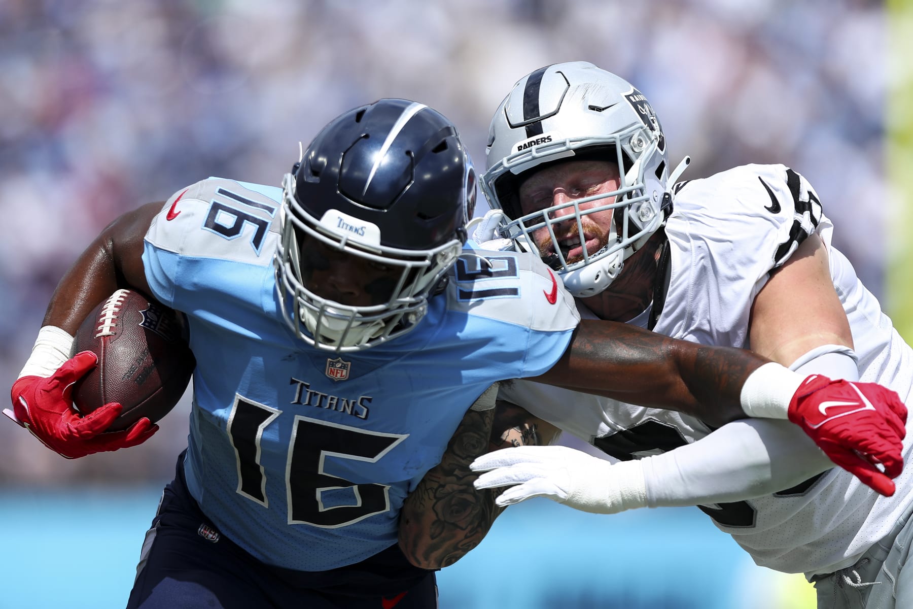 NASHVILLE, TN - SEPTEMBER 25: Maxx Crosby #98 of the Las Vegas Raiders tackles Treylon Burks #16 of the Tennessee Titans during an NFL football game at Nissan Stadium on September 25, 2022 in Nashville, Tennessee. (Photo by Kevin Sabitus/Getty Images)