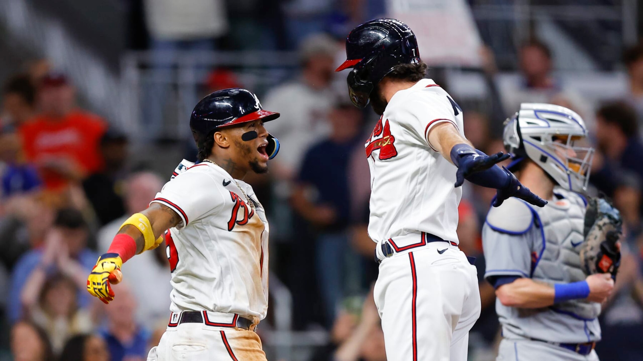 ATLANTA, GA - OCTOBER 01: Dansby Swanson #7 reacts with Ronald Acuna Jr. #13 of the Atlanta Braves after hitting a two run home run during the fifth inning against the New York Mets at Truist Park on October 1, 2022 in Atlanta, Georgia. (Photo by Todd Kirkland/Getty Images)