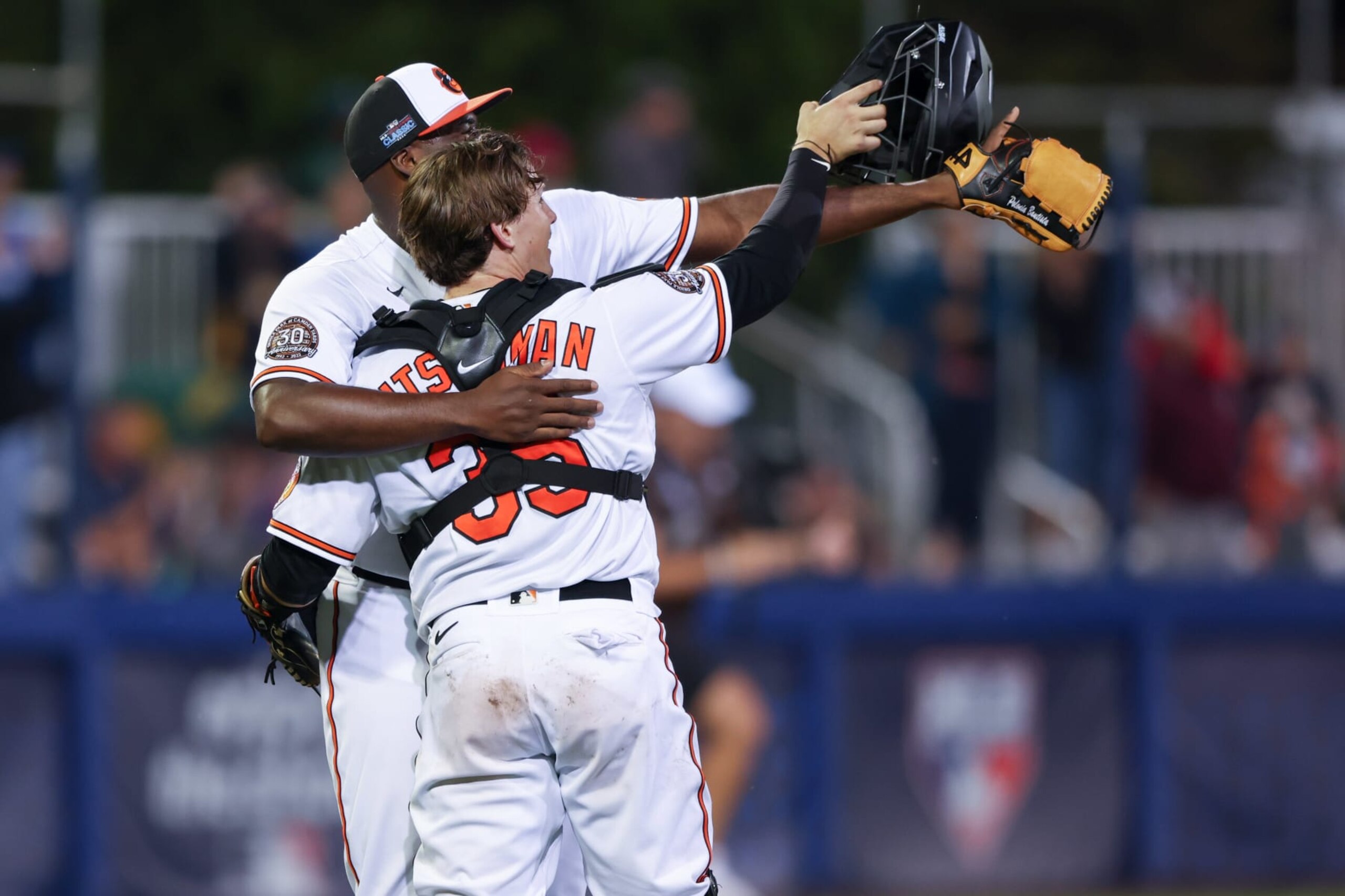 SOUTH WILLIAMSPORT, PA - AUGUST 21:   Adley Rutschman #35 and Felix Bautista #74 of the Baltimore Orioles celebrate after their win over the Boston Red Sox at Muncy Bank Ballpark at Historic Bowman Field on Sunday, August 21, 2022 in South Williamsport, Pennsylvania. (Photo by Mary DeCicco/MLB Photos via Getty Images)