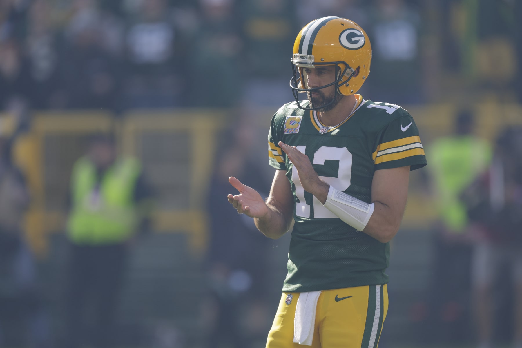 Green Bay Packers quarterback Aaron Rodgers watches player introductions before an NFL football game against the New England Patriots Sunday, Oct. 2, 2022, in Green Bay, Wis. (AP Photo/Matt Ludtke)