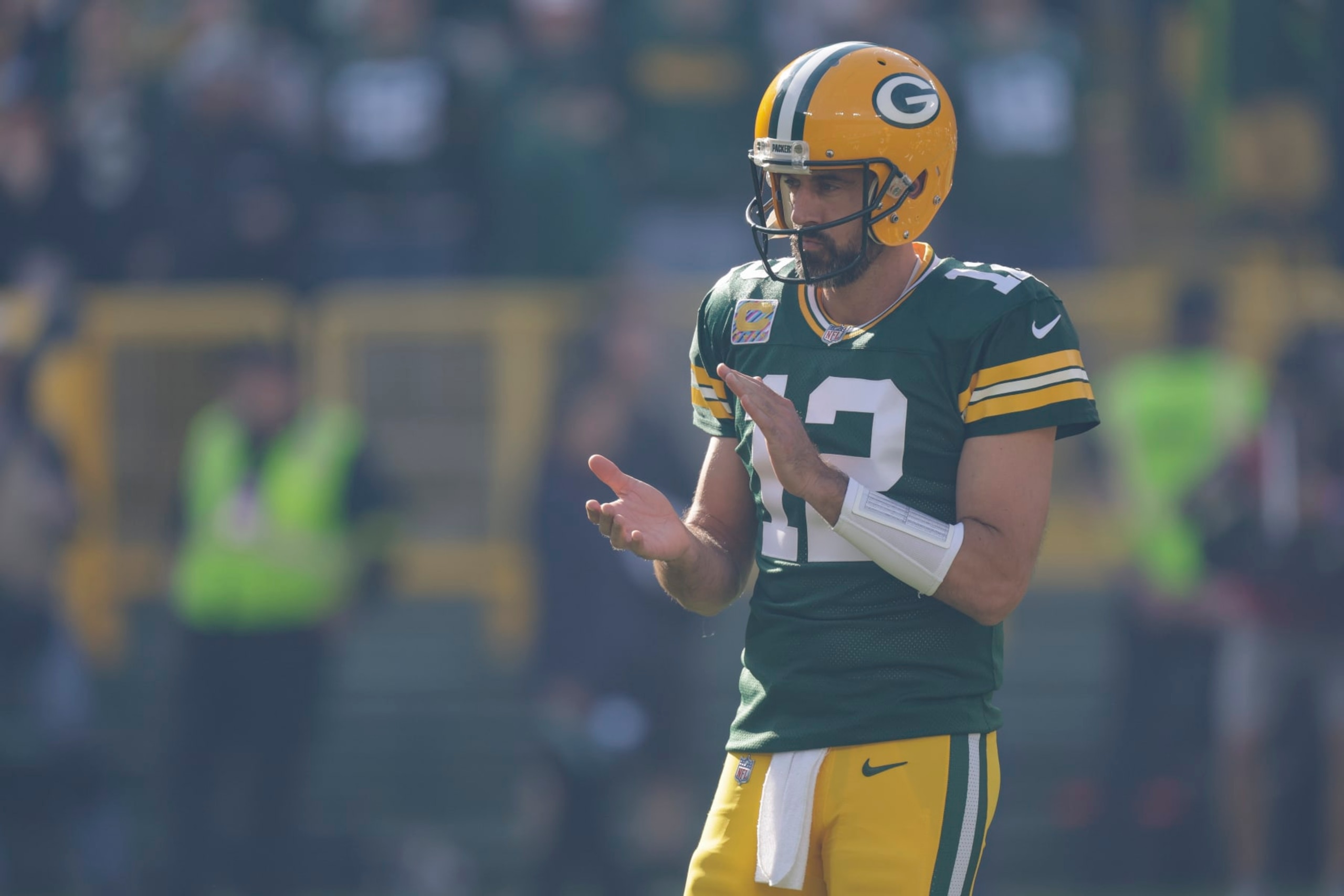 Green Bay Packers quarterback Aaron Rodgers watches player introductions before an NFL football game against the New England Patriots Sunday, Oct. 2, 2022, in Green Bay, Wis. (AP Photo/Matt Ludtke)