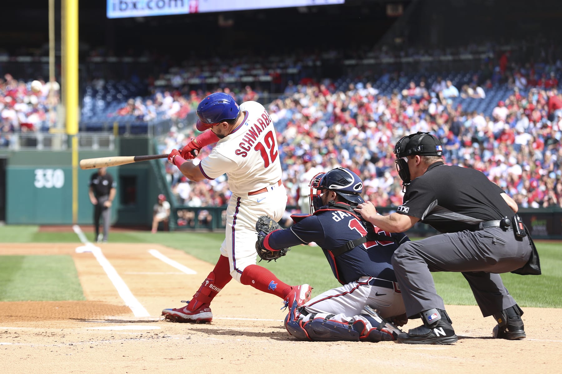 PHILADELPHIA, PENNSYLVANIA - SEPTEMBER 25: Kyle Schwarber #12 of the Philadelphia Phillies hits a solo home run during the first inning against the Atlanta Braves at Citizens Bank Park on September 25, 2022 in Philadelphia, Pennsylvania. (Photo by Tim Nwachukwu/Getty Images)