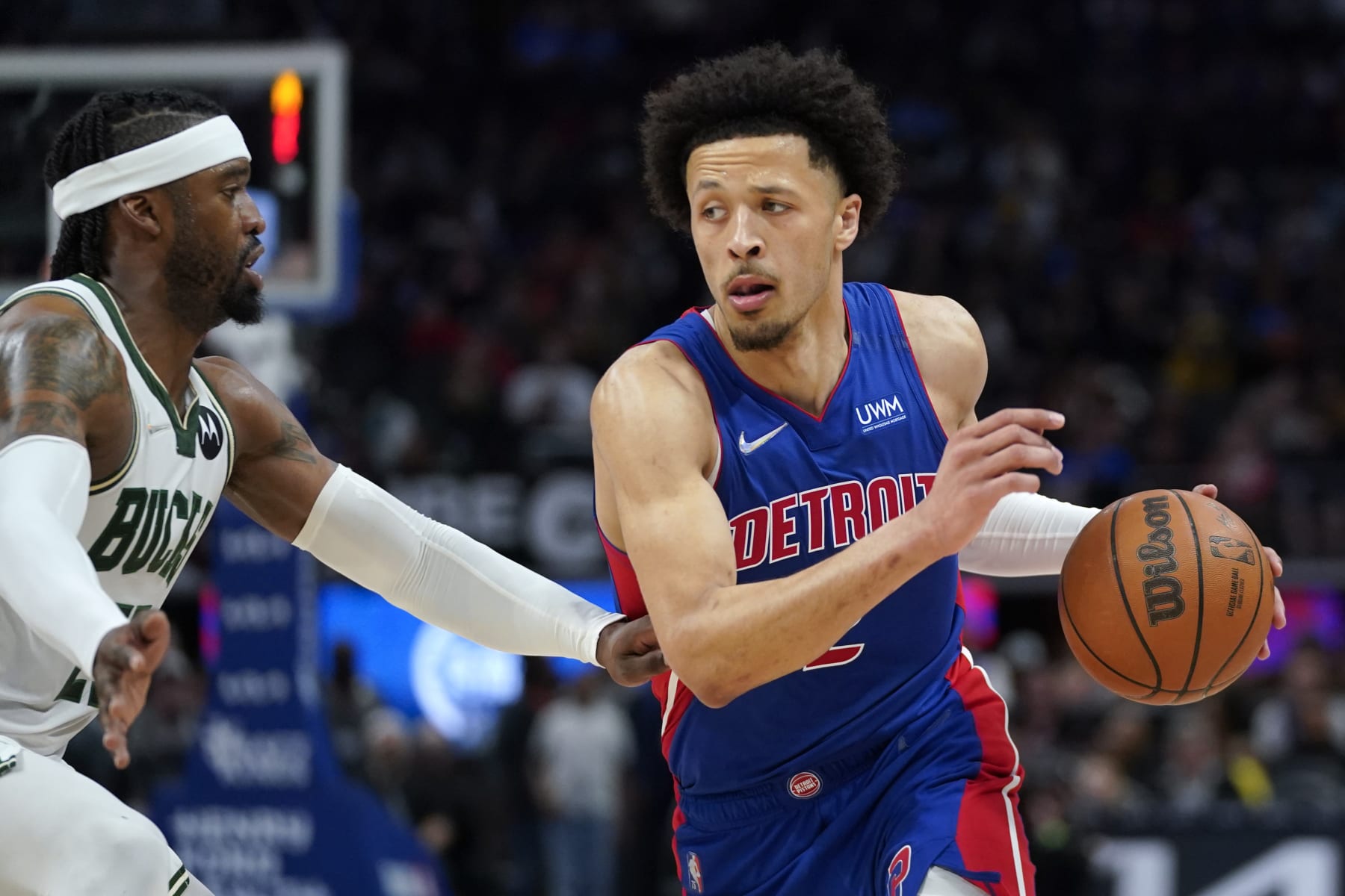 Detroit Pistons guard Cade Cunningham (2) drives on Milwaukee Bucks guard Wesley Matthews (23) in the second half of an NBA basketball game in Detroit, Friday, April 8, 2022. (AP Photo/Paul Sancya)