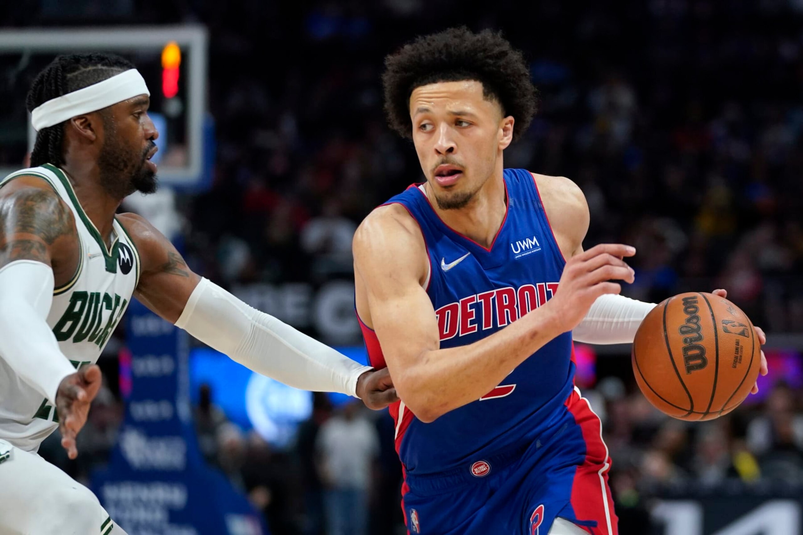 Detroit Pistons guard Cade Cunningham (2) drives on Milwaukee Bucks guard Wesley Matthews (23) in the second half of an NBA basketball game in Detroit, Friday, April 8, 2022. (AP Photo/Paul Sancya)
