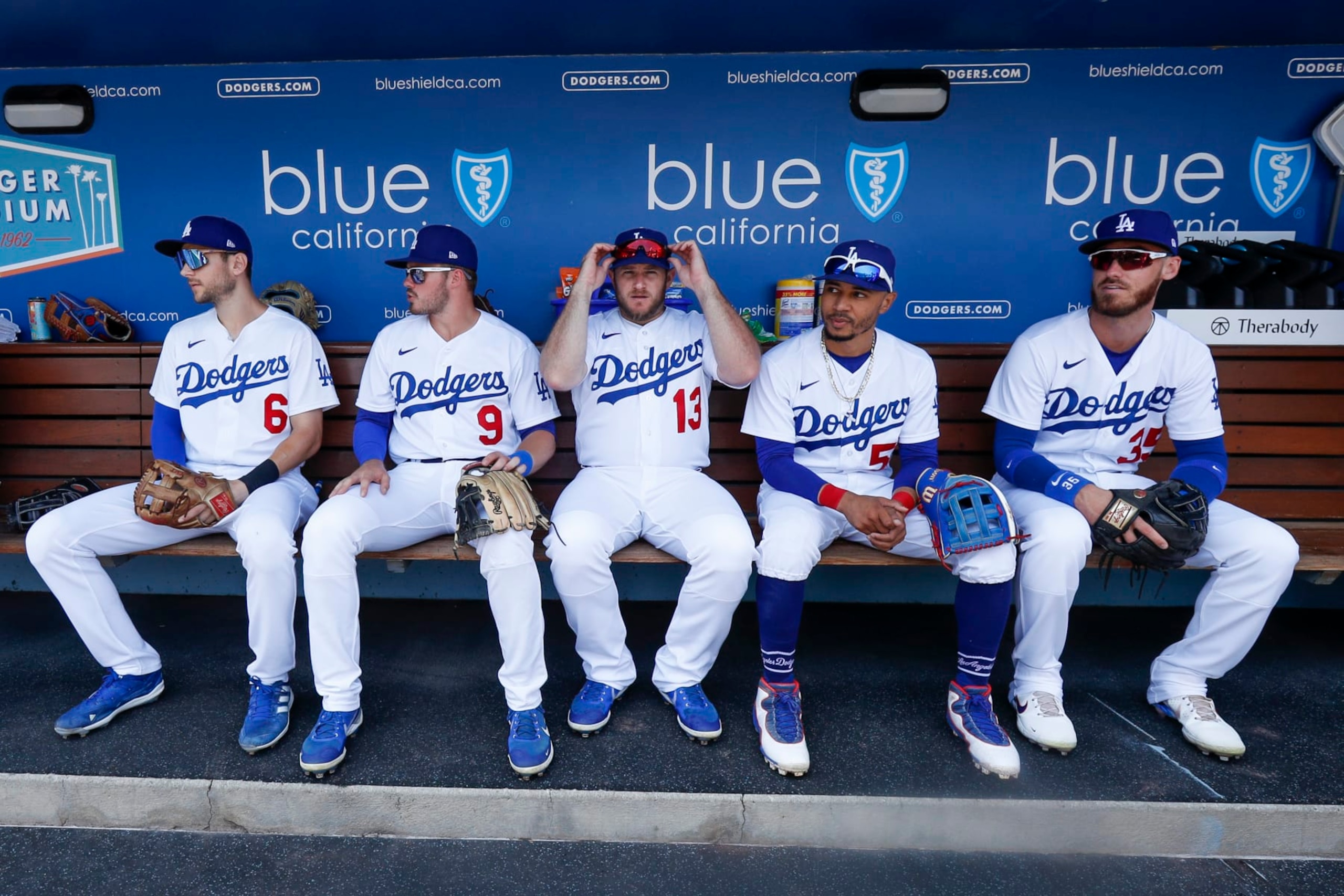 LOS ANGELES, CA - JULY 24: Los Angeles Dodgers first baseman Freddie Freeman (5), shortstop Trea Turner (6), second baseman Gavin Lux (9), third baseman Max Muncy (13), right fielder Mookie Betts (50), and center fielder Cody Bellinger (35) sit in the dugout prior to a regular season game between the San Francisco Giants and Los Angeles Dodgers on July 24, 2022, at Dodger Stadium in Los Angeles, CA. (Photo by Brandon Sloter/Icon Sportswire via Getty Images) LOS ANGELES, CA - JULY 24: Los Angeles Dodgers first baseman Freddie Freeman (5), shortstop Trea Turner (6), second baseman Gavin Lux (9), third baseman Max Muncy (13), right fielder Mookie Betts (50), and center fielder Cody Bellinger (35) sit in the dugout prior to a regular season game between the San Francisco Giants and Los Angeles Dodgers on July 24, 2022, at Dodger Stadium in Los Angeles, CA. (Photo by Brandon Sloter/Icon Sportswire via Getty Images)