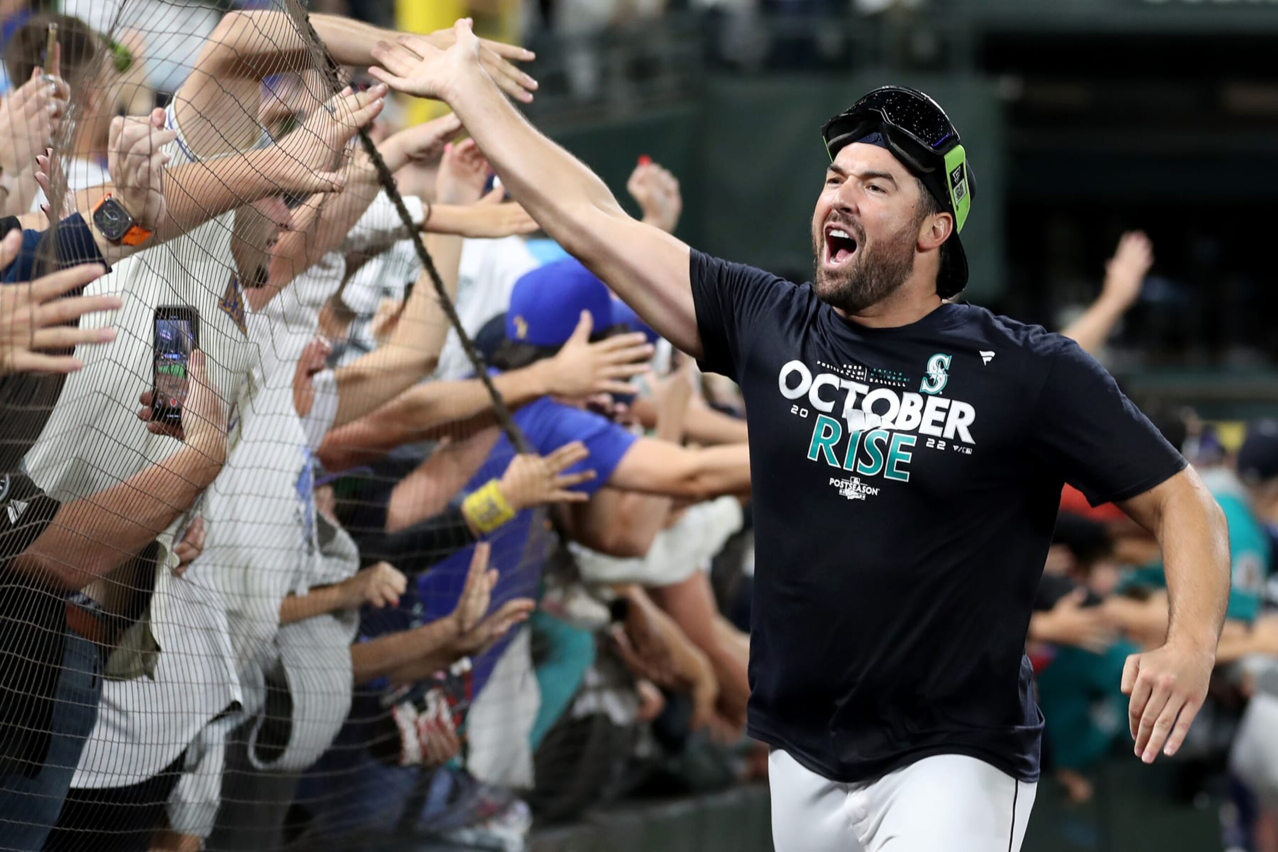 SEATTLE, WASHINGTON - SEPTEMBER 30: Robbie Ray #38 of the Seattle Mariners celebrates with fans after clinching a postseason birth after beating the Oakland Athletics 2-1 at T-Mobile Park on September 30, 2022 in Seattle, Washington. The Seattle Mariners have clinched a postseason appearance for the first time  in 21 years, the longest playoff drought in North American professional sports. (Photo by Steph Chambers/Getty Images)