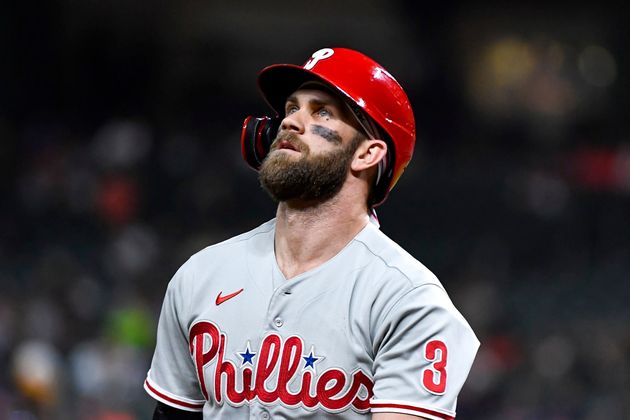 HOUSTON, TEXAS - OCTOBER 04: Bryce Harper #3 of the Philadelphia Phillies walks to the dugout after striking out in the first inning against the Houston Astros at Minute Maid Park on October 04, 2022 in Houston, Texas. (Photo by Logan Riely/Getty Images)
