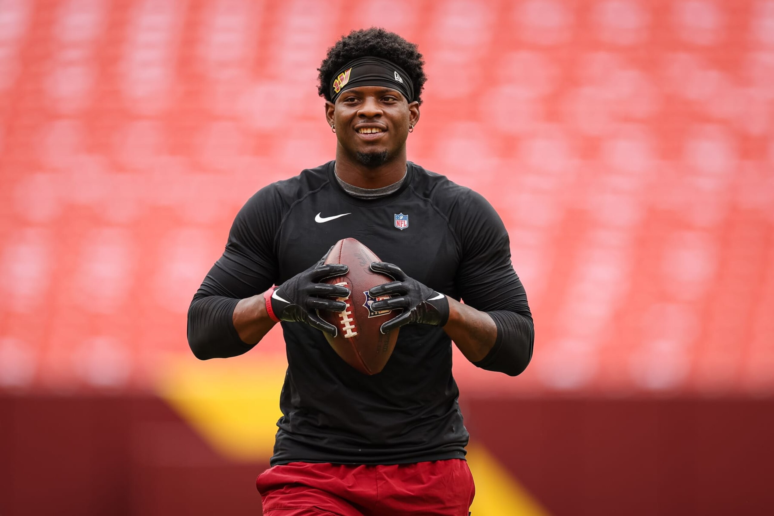 LANDOVER, MD - SEPTEMBER 25: Brian Robinson #8 of the Washington Commanders warms up before the game against the Philadelphia Eagles at FedExField on September 25, 2022 in Landover, Maryland. Robinson was shot twice in the leg during an attempted robbery on August 28, 2022. (Photo by Scott Taetsch/Getty Images)
