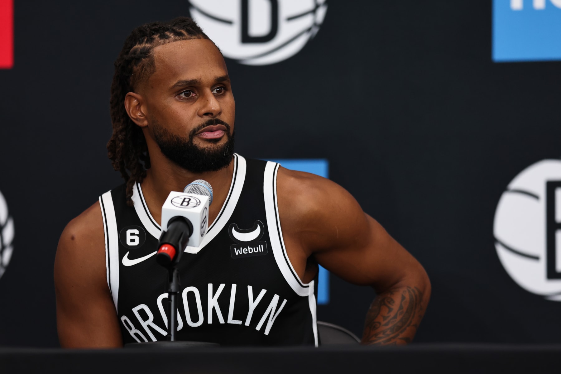 NEW YORK, NEW YORK - SEPTEMBER 26: Patty Mills #8 of the Brooklyn Nets speaks at the podium during a press conference at Brooklyn Nets Media Day at HSS Training Center on September 26, 2022 in the Brooklyn borough of New York City. NOTE TO USER: User expressly acknowledges and agrees that, by downloading and/or using this photograph, User is consenting to the terms and conditions of the Getty Images License Agreement. (Photo by Dustin Satloff/Getty Images)