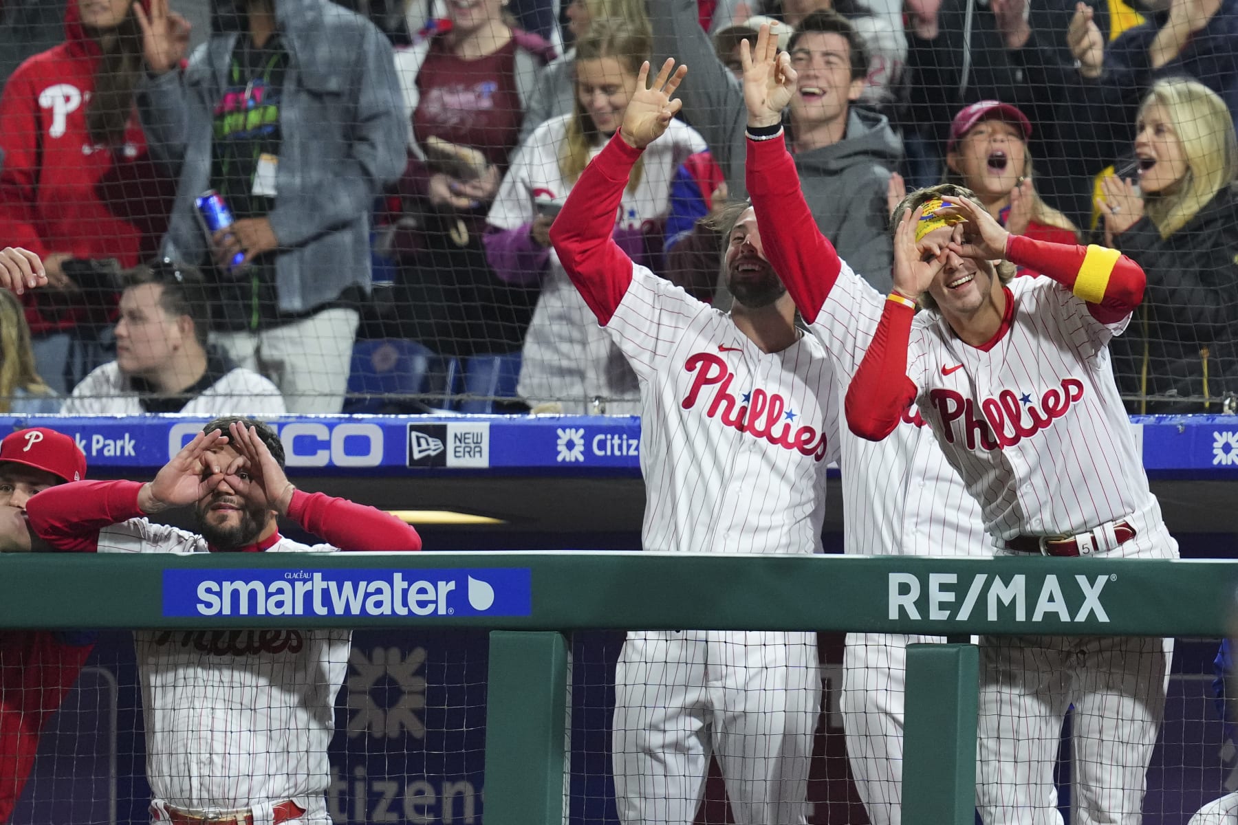 PHILADELPHIA, PA - SEPTEMBER 23: Kyle Schwarber #12, Matt Vierling #19, and Bryson Stott #5 of the Philadelphia Phillies react after an RBI triple by Alec Bohm #28 in the bottom of the fourth inning against the Atlanta Braves at Citizens Bank Park on September 23, 2022 in Philadelphia, Pennsylvania. (Photo by Mitchell Leff/Getty Images)