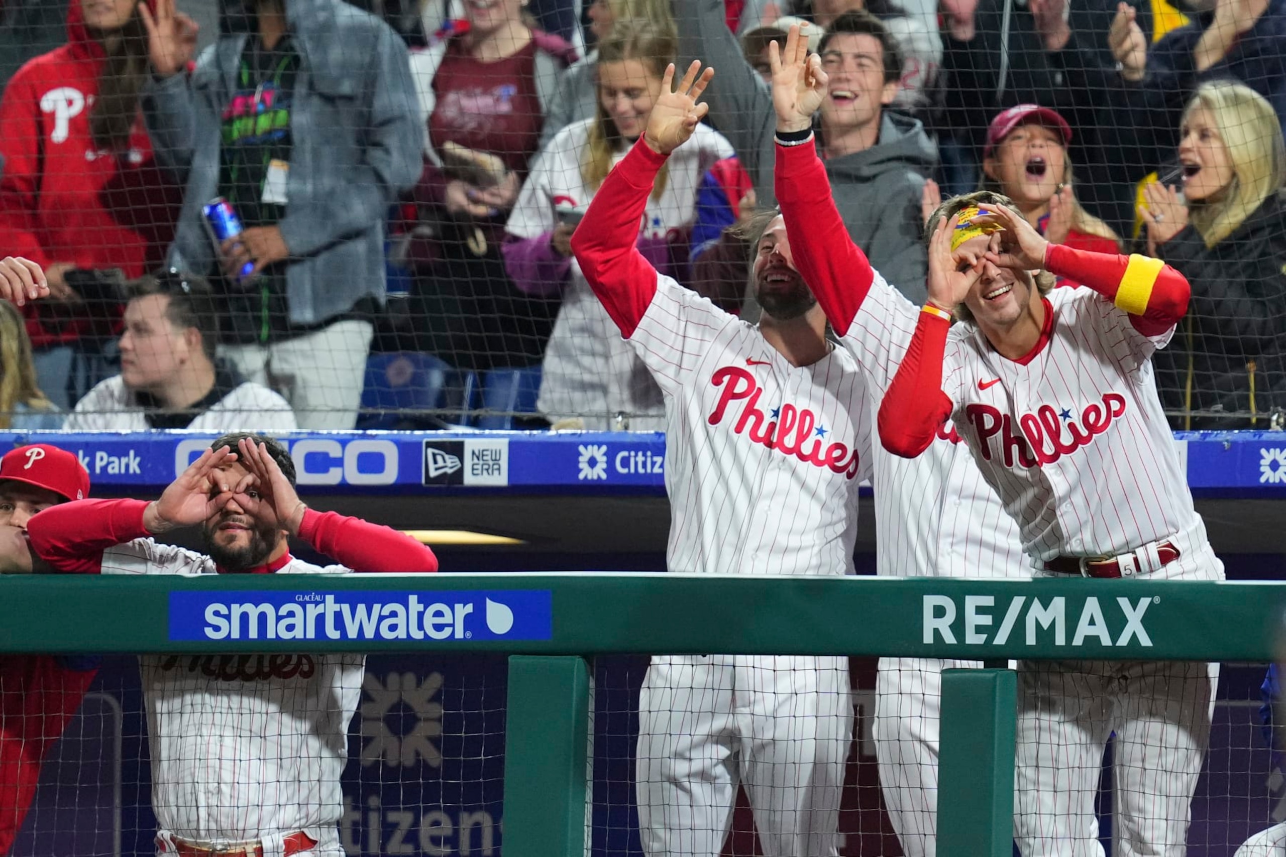 PHILADELPHIA, PA - SEPTEMBER 23: Kyle Schwarber #12, Matt Vierling #19, and Bryson Stott #5 of the Philadelphia Phillies react after an RBI triple by Alec Bohm #28 in the bottom of the fourth inning against the Atlanta Braves at Citizens Bank Park on September 23, 2022 in Philadelphia, Pennsylvania. (Photo by Mitchell Leff/Getty Images)