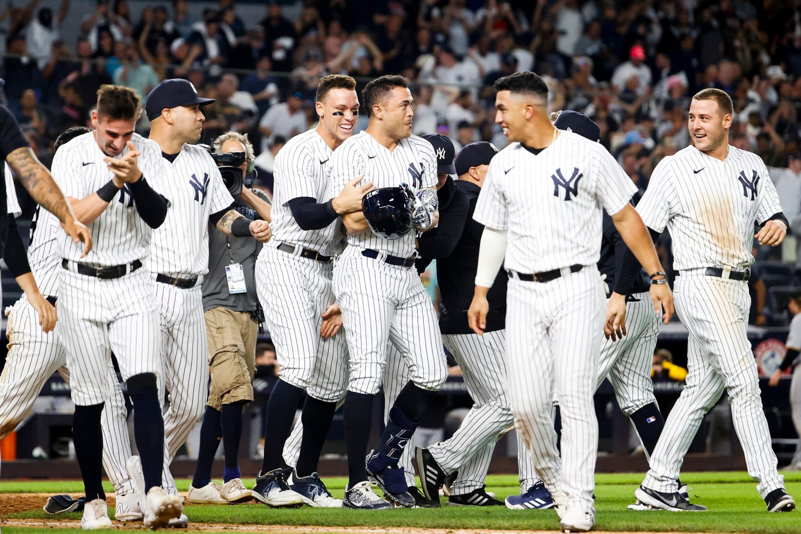 NEW YORK, NY - SEPTEMBER 20: The New York Yankees celebrate after Giancarlo Stanton #27 of the New York Yankees hits a walk-off grand-slam home run to end the game during the 9th inning of the game against the Pittsburgh Pirates at Yankee Stadium on September 20, 2022, in New York City. (Photo by New York Yankees/Getty Images)