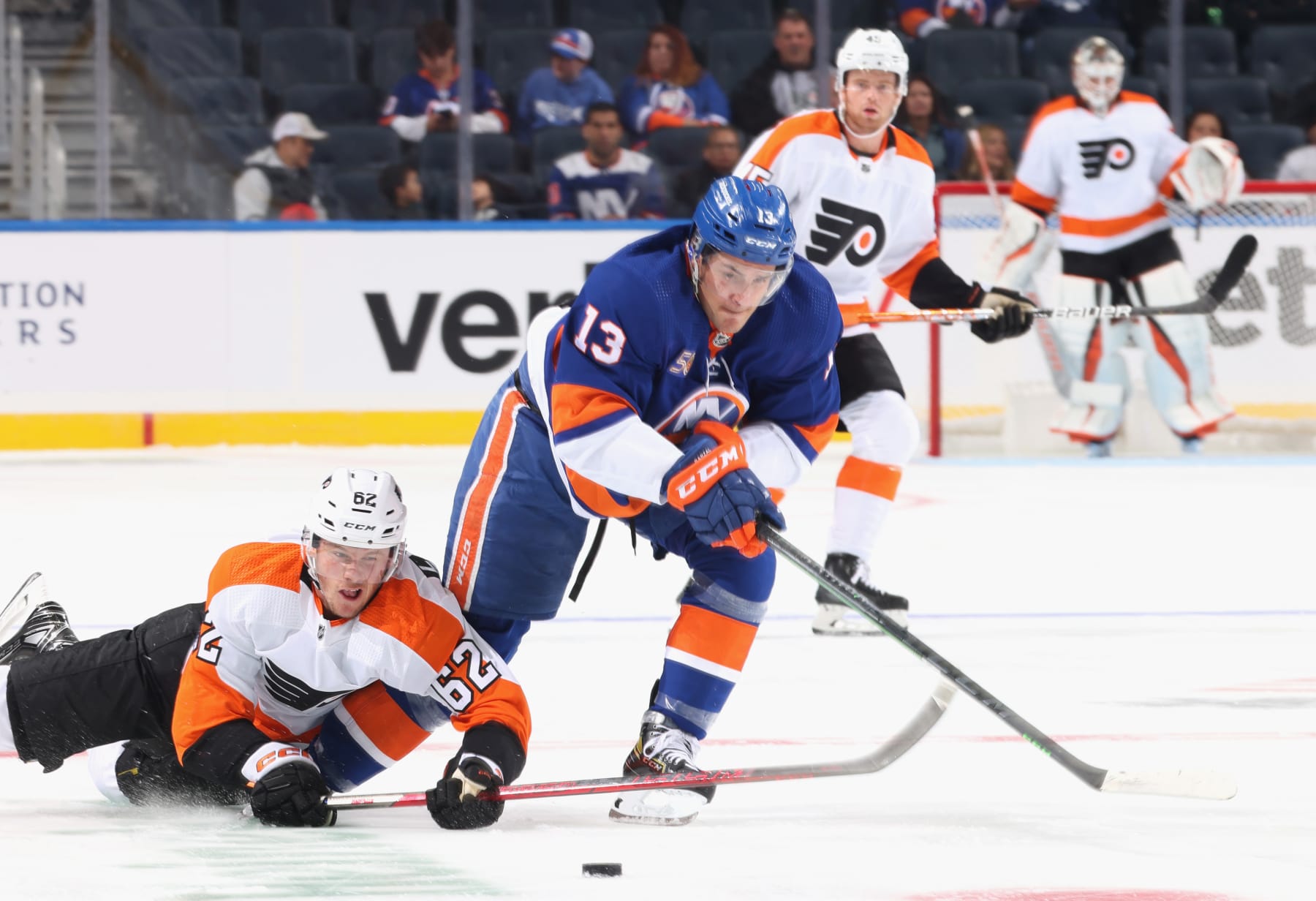 ELMONT, NEW YORK - OCTOBER 02: Mathew Barzal #13 of the New York Islanders carries the puck past Olle Lycksell #62 of the Philadelphia Flyers during the first period at the UBS Arena on October 02, 2022 in Elmont, New York. (Photo by Bruce Bennett/Getty Images)