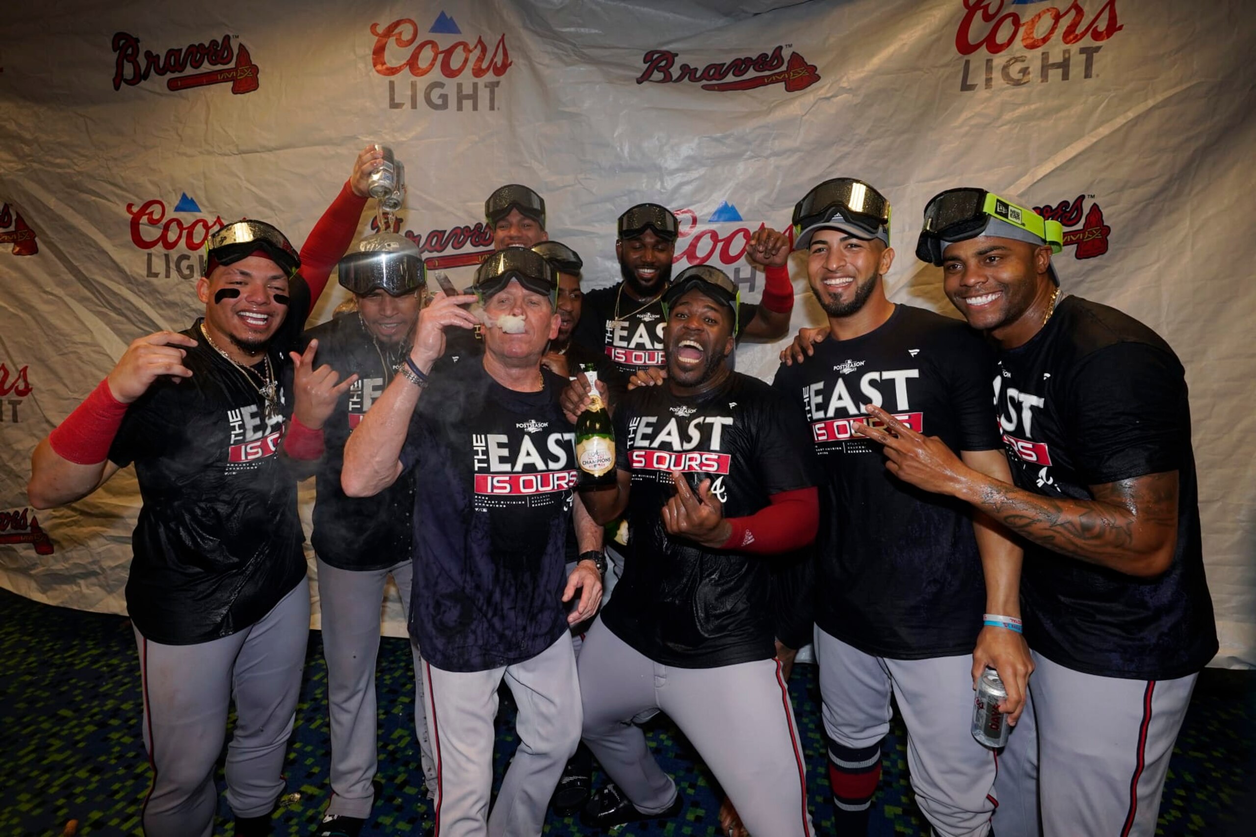Atlanta Braves players celebrate in the club house after clinching their fifth consecutive NL East title by defeating the Miami Marlins 2-1, in a baseball game, Tuesday, Oct. 4, 2022, in Miami. (AP Photo/Wilfredo Lee)