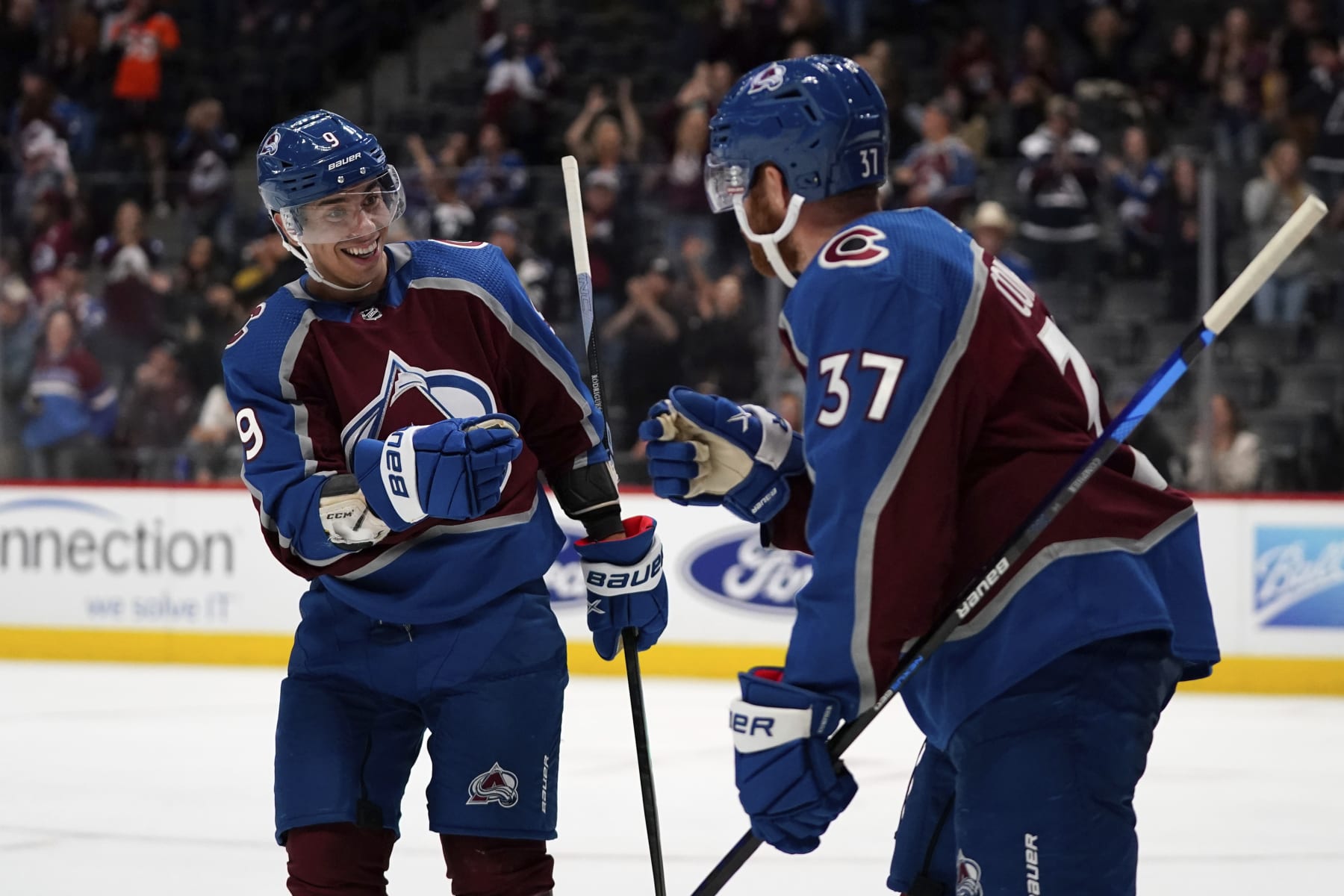 Colorado Avalanche's Evan Rodrigues, left, congratulates teammate J.T. Compher on his goal in the third period of an NHL preseason hockey game against the Vegas Golden Knights Sunday, Sept. 25, 2022, in Denver. (AP Photo/Geneva Heffernan)