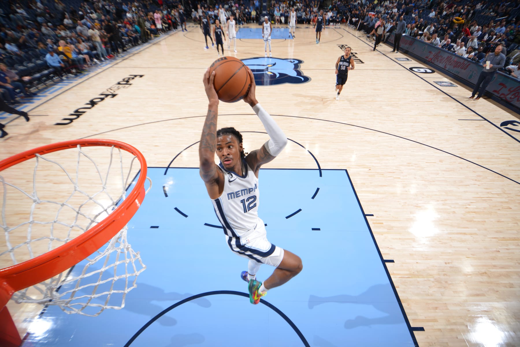 MEMPHIS, TN - OCTOBER 3: Ja Morant #12 of the Memphis Grizzlies dunks the ball against the Orlando Magic during a preseason game on October 3, 2022 at FedExForum in Memphis, Tennessee. NOTE TO USER: User expressly acknowledges and agrees that, by downloading and or using this photograph, User is consenting to the terms and conditions of the Getty Images License Agreement. Mandatory Copyright Notice: Copyright 2022 NBAE (Photo by Jesse D. Garrabrant/NBAE via Getty Images)