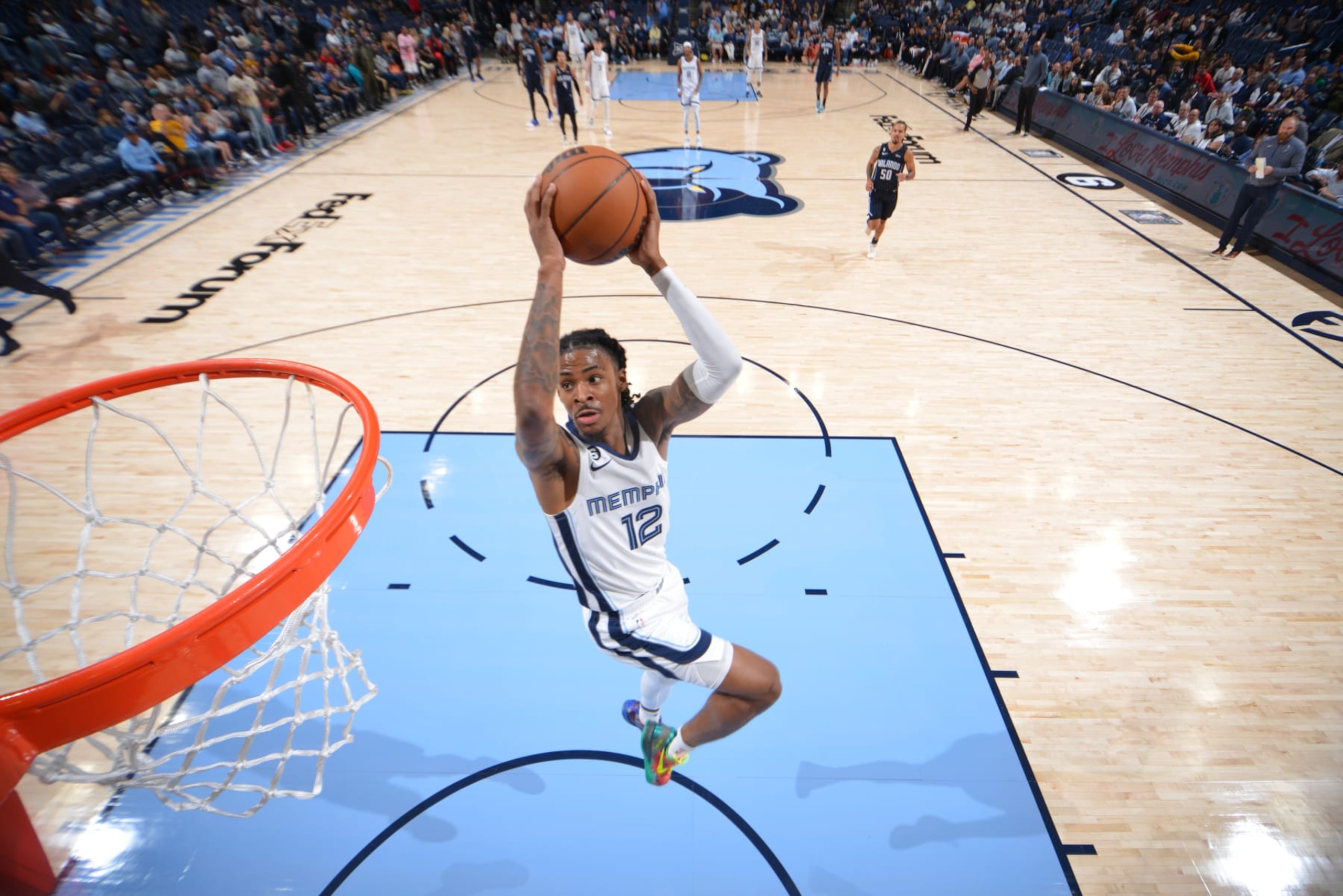 MEMPHIS, TN - OCTOBER 3: Ja Morant #12 of the Memphis Grizzlies dunks the ball against the Orlando Magic during a preseason game on October 3, 2022 at FedExForum in Memphis, Tennessee. NOTE TO USER: User expressly acknowledges and agrees that, by downloading and or using this photograph, User is consenting to the terms and conditions of the Getty Images License Agreement. Mandatory Copyright Notice: Copyright 2022 NBAE (Photo by Jesse D. Garrabrant/NBAE via Getty Images) MEMPHIS, TN - OCTOBER 3: Ja Morant #12 of the Memphis Grizzlies dunks the ball against the Orlando Magic during a preseason game on October 3, 2022 at FedExForum in Memphis, Tennessee. NOTE TO USER: User expressly acknowledges and agrees that, by downloading and or using this photograph, User is consenting to the terms and conditions of the Getty Images License Agreement. Mandatory Copyright Notice: Copyright 2022 NBAE (Photo by Jesse D. Garrabrant/NBAE via Getty Images)