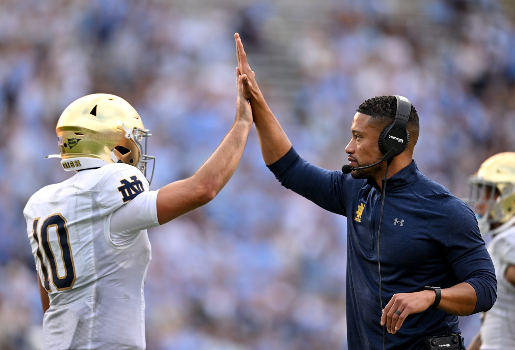 CHAPEL HILL, NORTH CAROLINA - SEPTEMBER 24: Head coach Marcus Freeman high-fives Drew Pyne #10 of the Notre Dame Fighting Irish after a touchdown drive against the North Carolina Tar Heels during the second half of their game at Kenan Memorial Stadium on September 24, 2022 in Chapel Hill, North Carolina. Notre Dame won 45-32. (Photo by Grant Halverson/Getty Images)