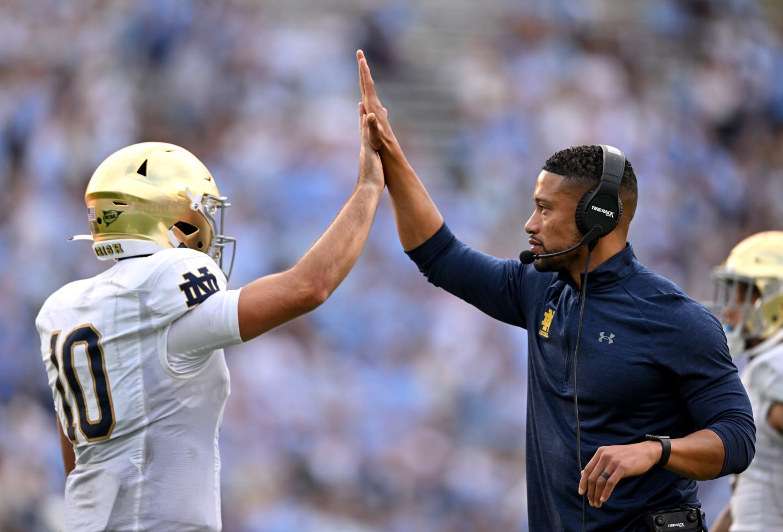 CHAPEL HILL, NORTH CAROLINA - SEPTEMBER 24: Head coach Marcus Freeman high-fives Drew Pyne #10 of the Notre Dame Fighting Irish after a touchdown drive against the North Carolina Tar Heels during the second half of their game at Kenan Memorial Stadium on September 24, 2022 in Chapel Hill, North Carolina. Notre Dame won 45-32. (Photo by Grant Halverson/Getty Images)