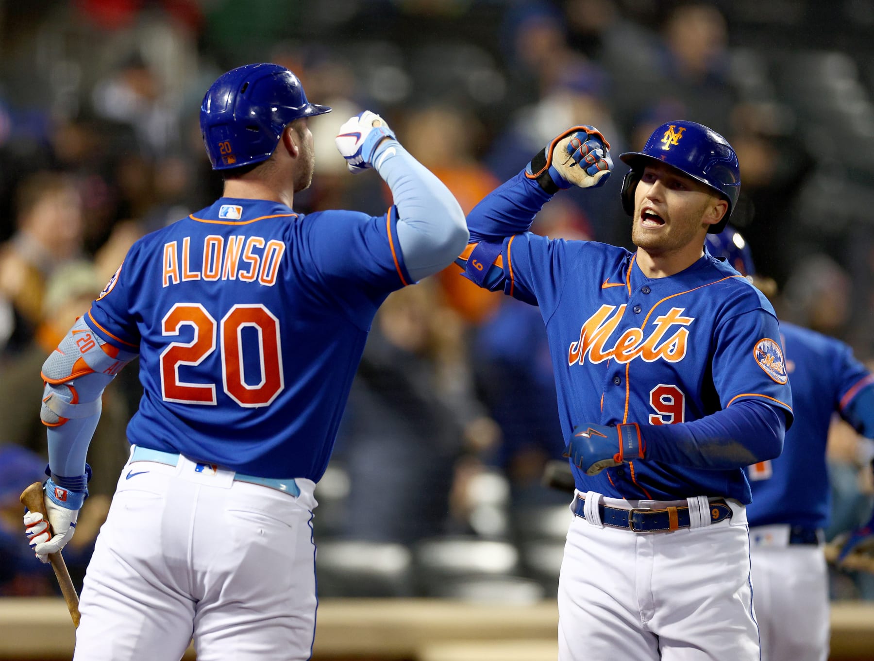 NEW YORK, NEW YORK - OCTOBER 04: Pete Alonso #20 of the New York Mets congratulates teammate Brandon Nimmo #9 after Nimmo hit a solo home run in the first inning against the Washington Nationals during game two of a double header at Citi Field on October 04, 2022 in the Flushing neighborhood of the Queens borough of New York City. (Photo by Elsa/Getty Images)