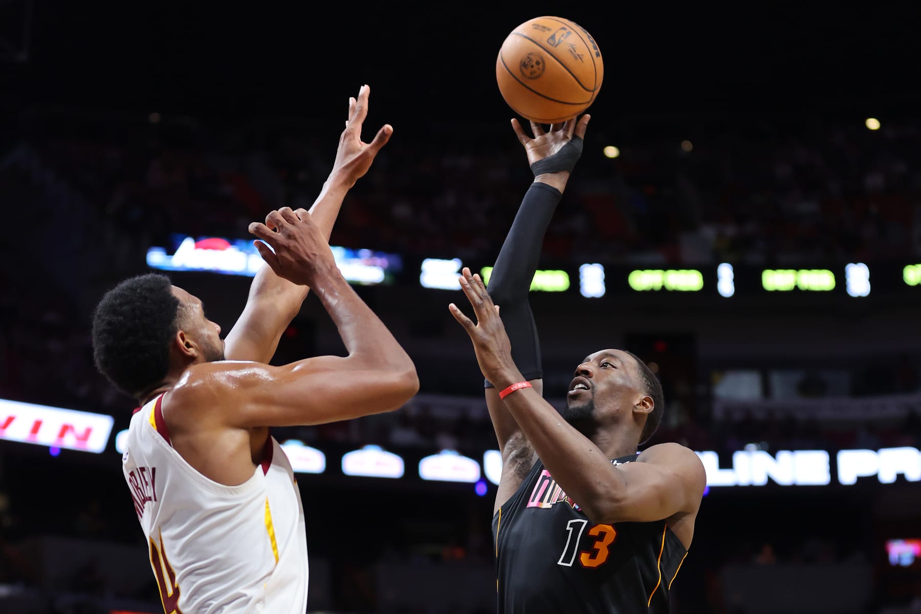 MIAMI, FLORIDA - MARCH 11: Bam Adebayo #13 of the Miami Heat shoots over Evan Mobley #4 of the Cleveland Cavaliers during the second half at FTX Arena on March 11, 2022 in Miami, Florida. NOTE TO USER: User expressly acknowledges and agrees that, by downloading and or using this photograph, User is consenting to the terms and conditions of the Getty Images License Agreement. (Photo by Michael Reaves/Getty Images)
