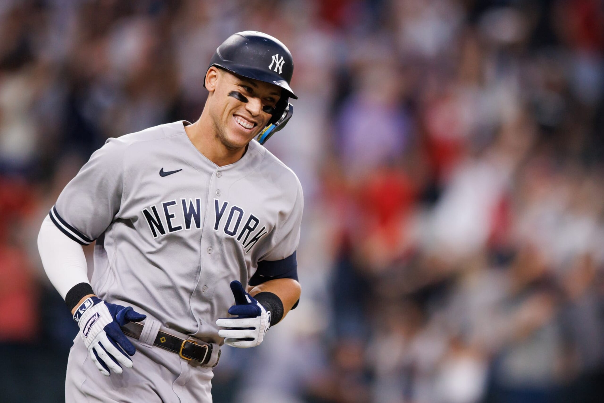 ARLINGTON, TX - OCTOBER 04: Aaron Judge #99 of the New York Yankees smiles as he rounds the bases after hitting his 62nd home run of the season against the Texas Rangers during the first inning in game two of a double header at Globe Life Field on October 4, 2022 in Arlington, Texas. (Photo by Bailey Orr/Texas Rangers/Getty Images)
