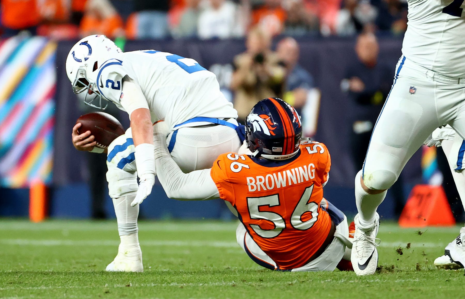 DENVER, COLORADO - OCTOBER 06: Matt Ryan #2 of the Indianapolis Colts is sacked by Baron Browning #56 of the Denver Broncos during a game  at Empower Field At Mile High on October 06, 2022 in Denver, Colorado. (Photo by Justin Tafoya/Getty Images)