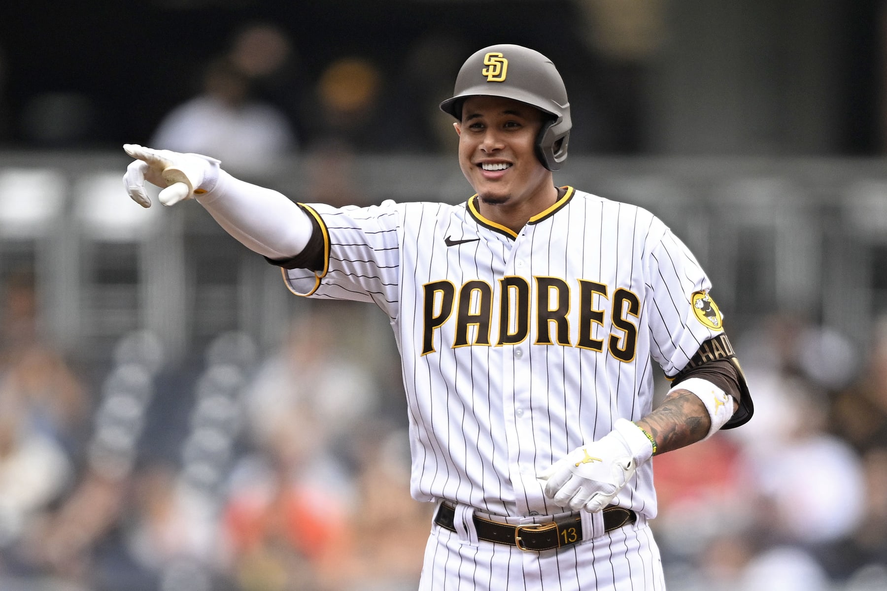 SAN DIEGO, CA - OCTOBER 5:  Manny Machado #13 of the San Diego Padres points back to the dugout after hitting a double during the first inning of a baseball game against the San Francisco Giants on October 5, 2022 at Petco Park in San Diego, California. (Photo by Denis Poroy/Getty Images)