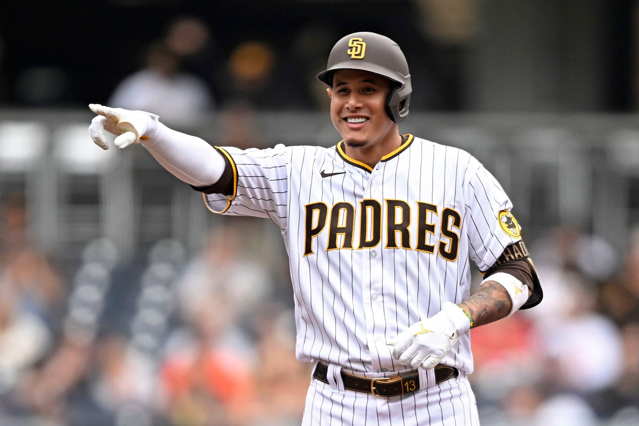 SAN DIEGO, CA - OCTOBER 5:  Manny Machado #13 of the San Diego Padres points back to the dugout after hitting a double during the first inning of a baseball game against the San Francisco Giants on October 5, 2022 at Petco Park in San Diego, California. (Photo by Denis Poroy/Getty Images)
