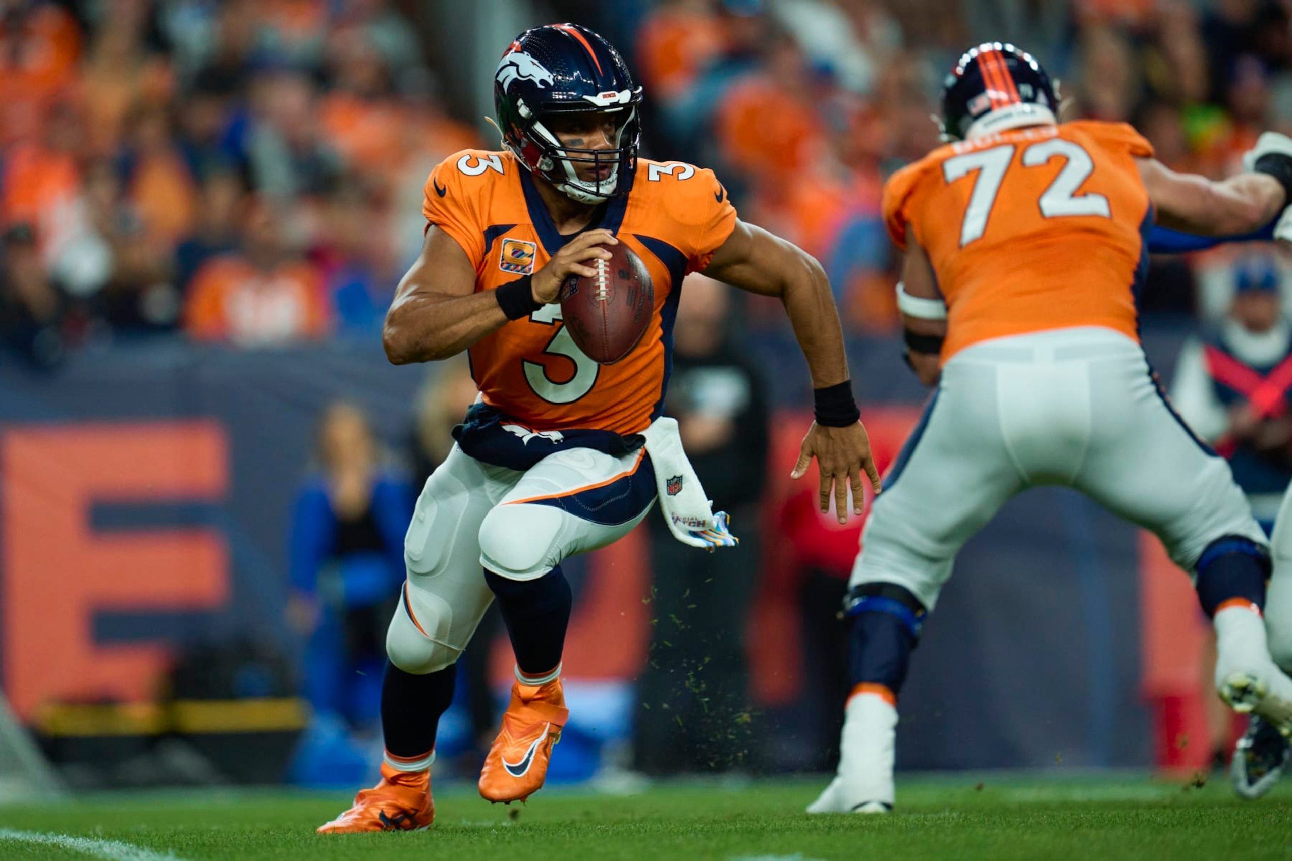DENVER, CO - OCTOBER 06: Russell Wilson #3 of the Denver Broncos scrambles against the Indianapolis Colts at Empower Field at Mile High on October 6, 2022 in Denver, Colorado. (Photo by Cooper Neill/Getty Images)