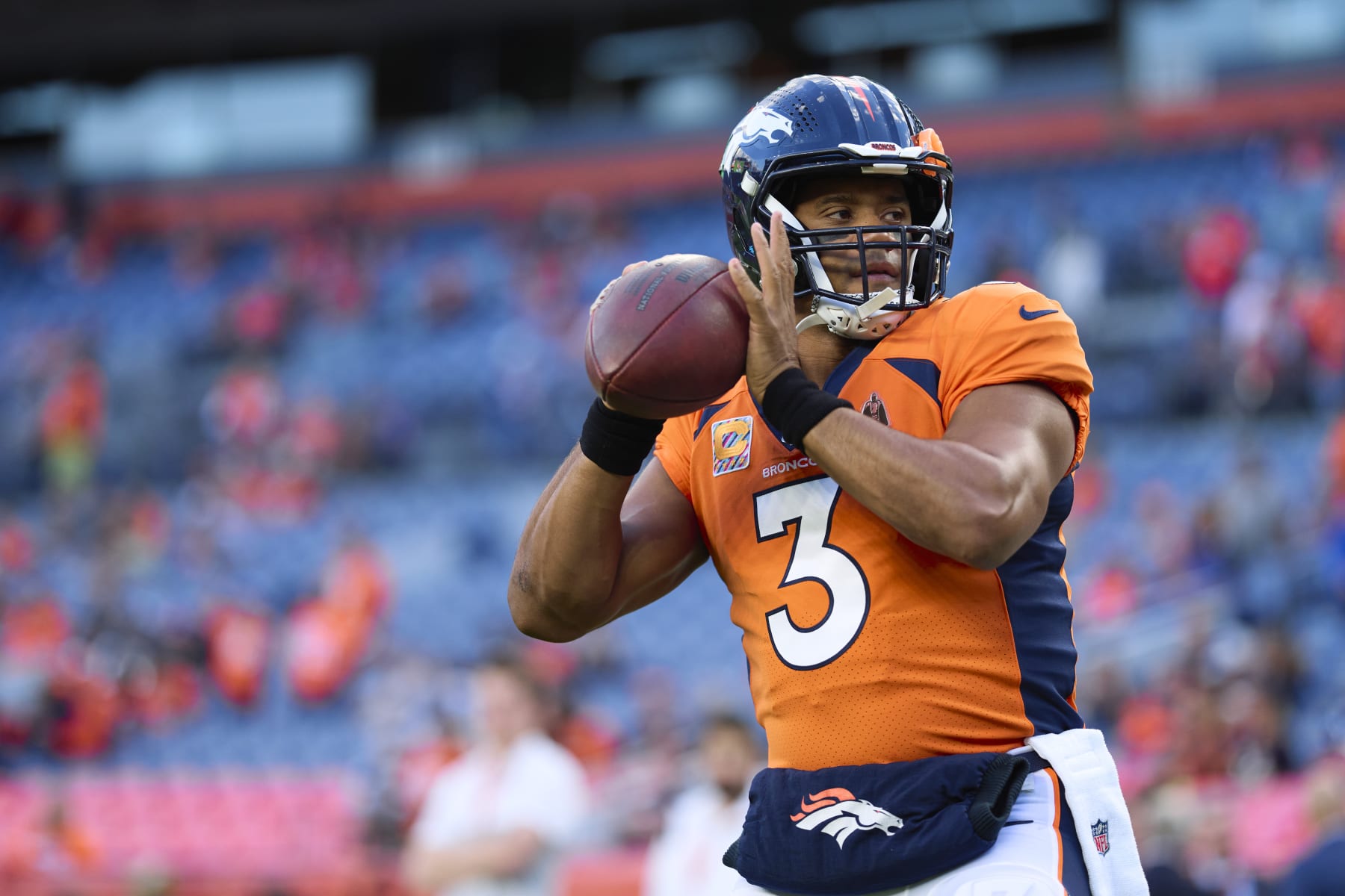 DENVER, CO - OCTOBER 06: Russell Wilson #3 of the Denver Broncos warms up before kickoff against the Indianapolis Colts at Empower Field at Mile High on October 6, 2022 in Denver, Colorado. (Photo by Cooper Neill/Getty Images)