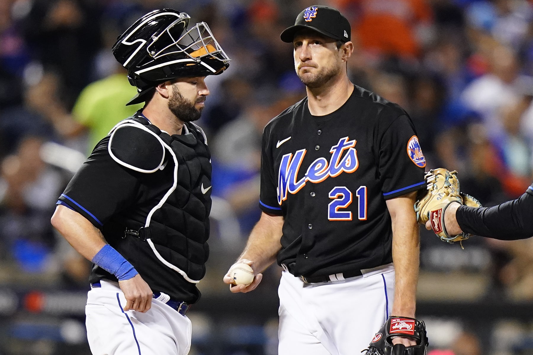 New York Mets starting pitcher Max Scherzer (21) waits on the mound with catcher Tomas Nido during a pitching change during the fifth inning of Game 1 of a National League wild-card baseball playoff series against the San Diego Padres, Friday, Oct. 7, 2022, in New York. (AP Photo/Frank Franklin II)