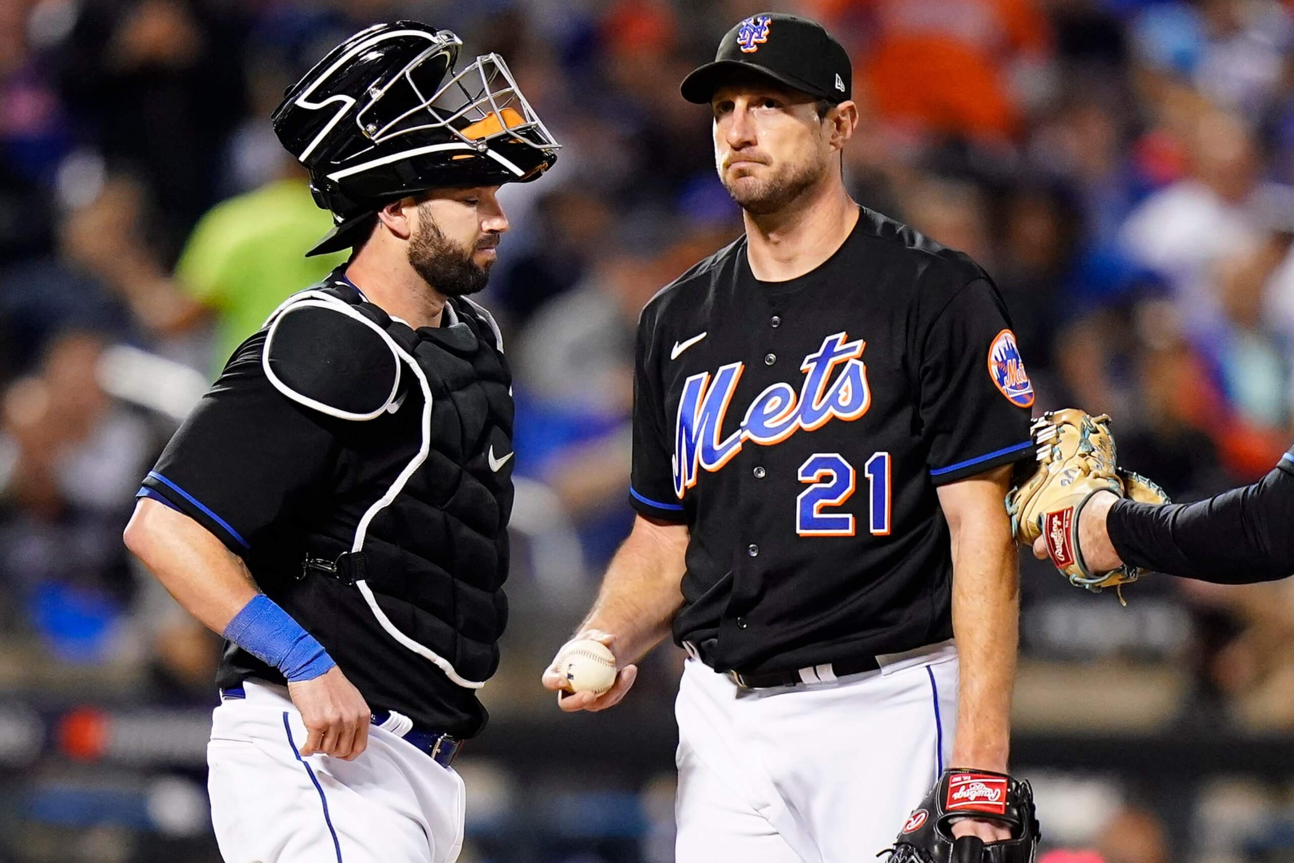 New York Mets starting pitcher Max Scherzer (21) waits on the mound with catcher Tomas Nido during a pitching change during the fifth inning of Game 1 of a National League wild-card baseball playoff series against the San Diego Padres, Friday, Oct. 7, 2022, in New York. (AP Photo/Frank Franklin II)