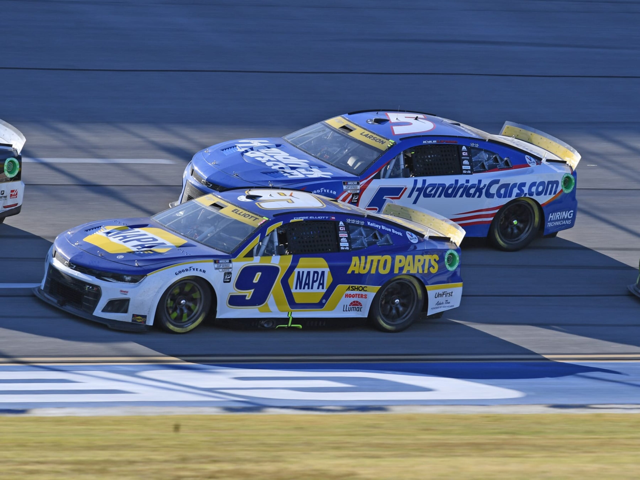 TALLADEGA, AL - OCTOBER 02: Chase Elliott (#9 Hendrick Motorsports NAPA Auto Parts Chevrolet) and Kyle Larson (#5 Hendrick Motorsports HendrickCars.com Chevrolet) race side by side during the running of the NASCAR Cup Series YellaWood 500 on October 02, 2022, at Talladega Superspeedway in Talladega, AL. (Photo by Jeffrey Vest/Icon Sportswire via Getty Images)