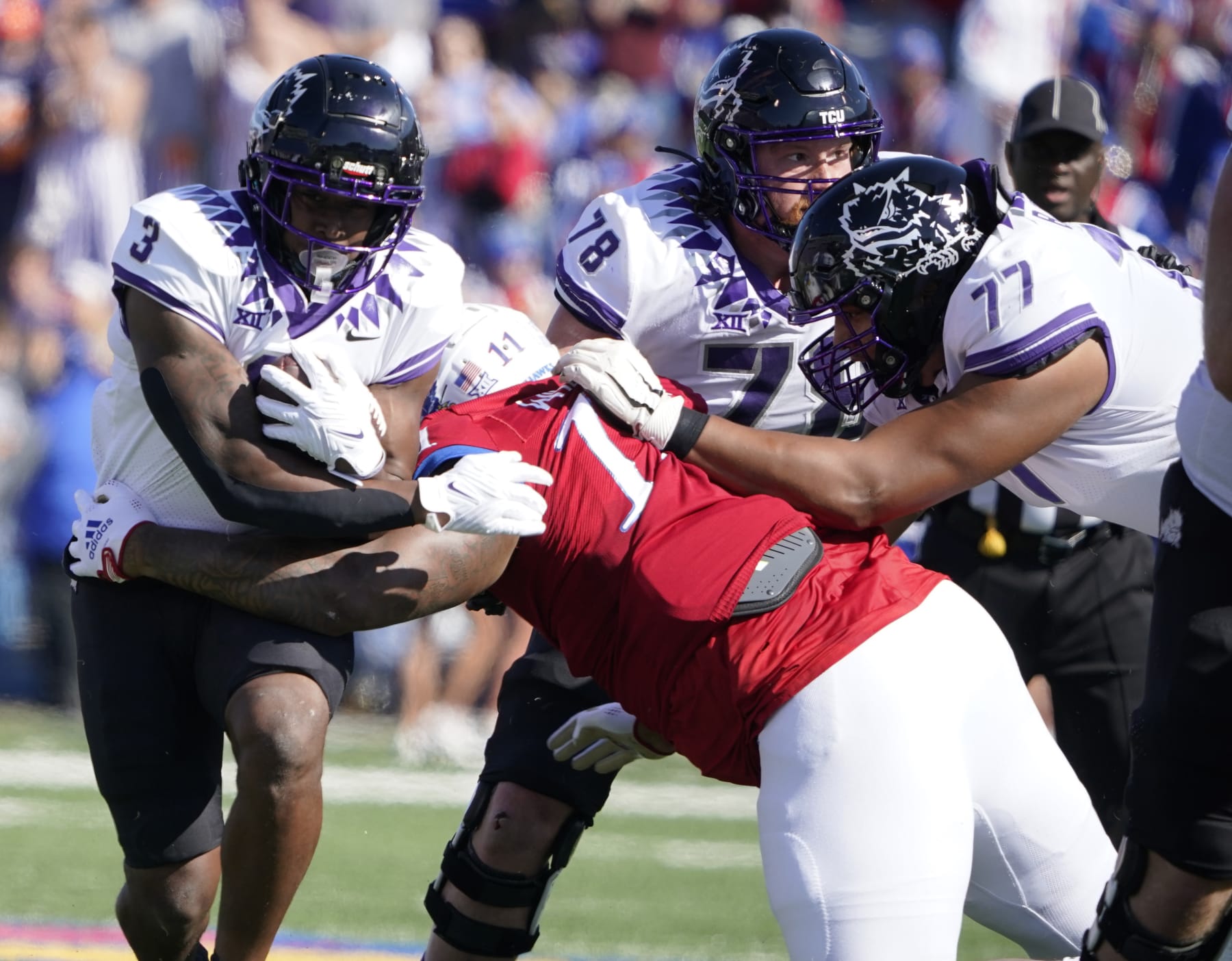 LAWRENCE, KANSAS - OCTOBER 08:  Running back Emari Demercado #3 of the TCU Horned Frogs rushes against defensive lineman Eddie Wilson #11 of the Kansas Jayhawks in the first half at David Booth Kansas Memorial Stadium on October 08, 2022 in Lawrence, Kansas. (Photo by Ed Zurga/Getty Images)
