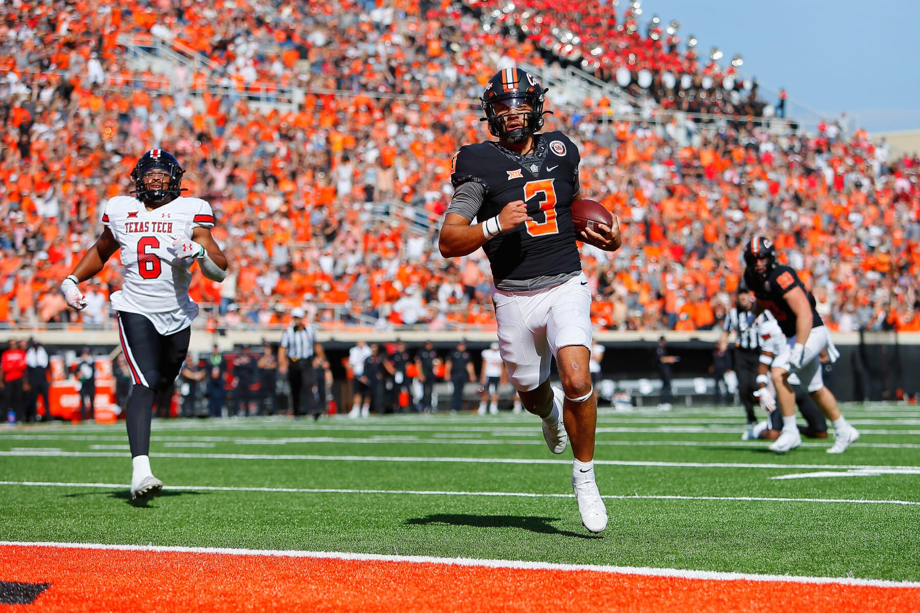 STILLWATER, OK - OCTOBER 8:  Quarterback Spencer Sanders #3 of the Oklahoma State Cowboys scores a touchdown on a 14-yard run in the first quarter against linebacker Kosi Eldridge #6 of the Texas Tech Red Raiders at Boone Pickens Stadium on October 8, 2022 in Stillwater, Oklahoma.   (Photo by Brian Bahr/Getty Images)