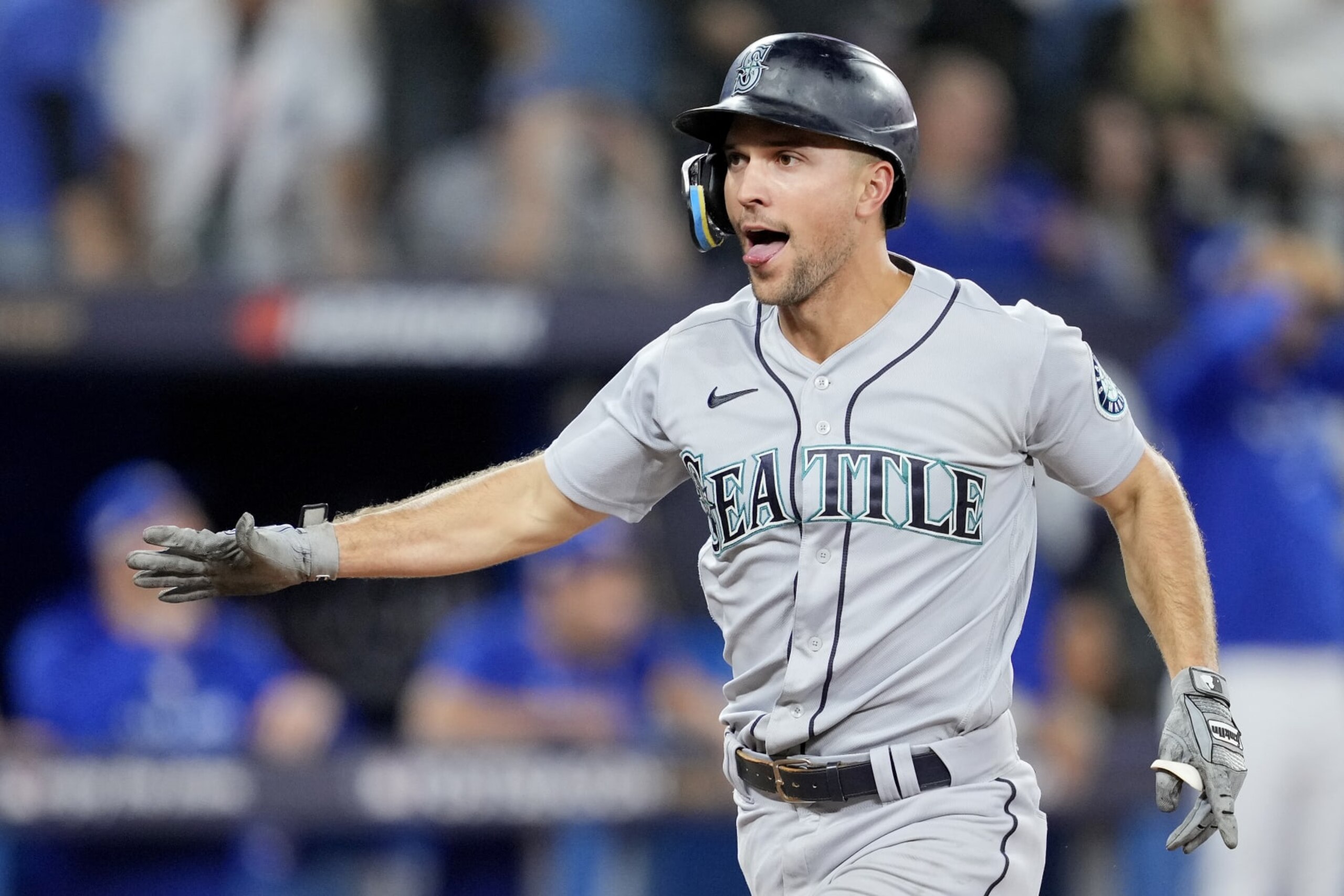TORONTO, ONTARIO - OCTOBER 08: Mitch Haniger #17 of the Seattle Mariners celebrates after scoring on a double hit by J.P. Crawford #3 against the Toronto Blue Jays during the eighth inning in game two of the American League Wild Card Series at Rogers Centre on October 08, 2022 in Toronto, Ontario. (Photo by Mark Blinch/Getty Images)