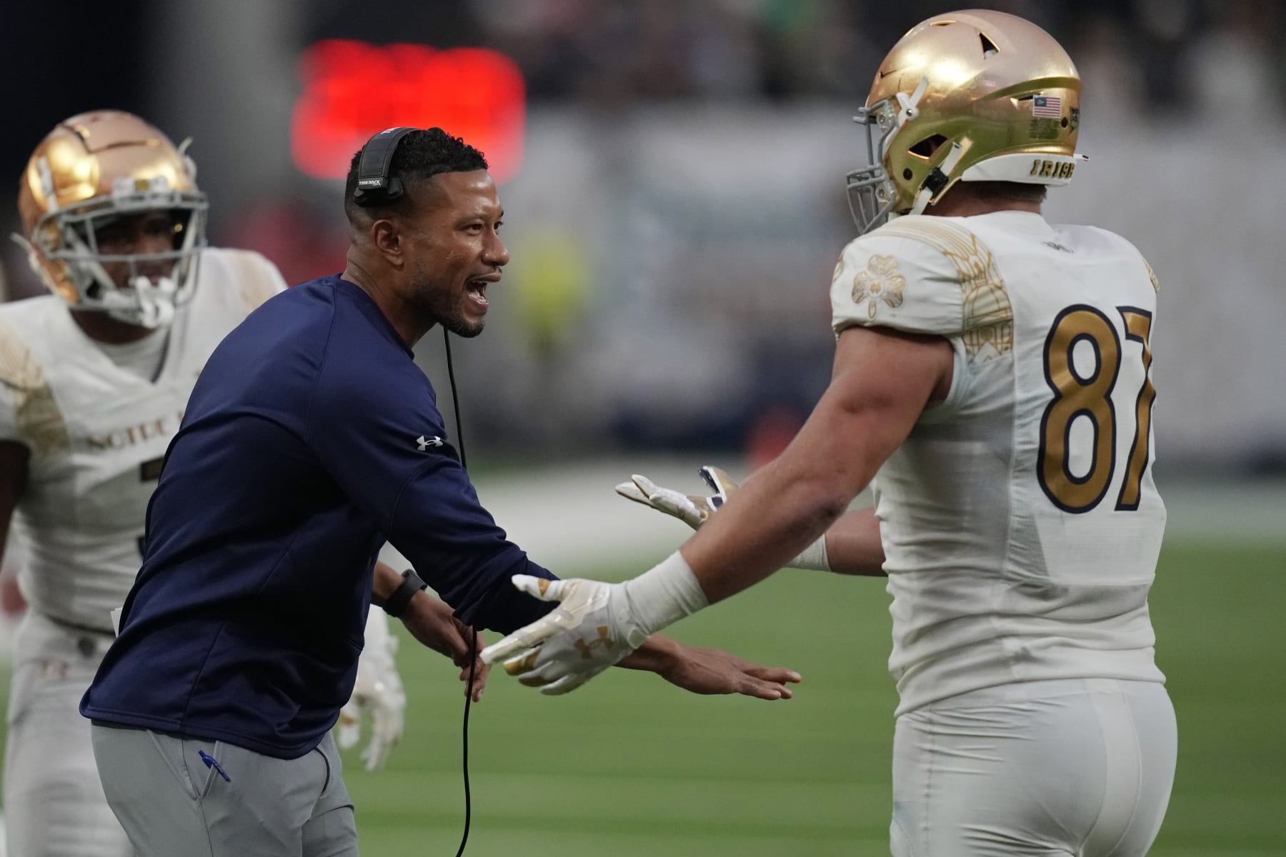 Notre Dame head coach Marcus Freeman, left, celebrates after Notre Dame tight end Michael Mayer (87) made a touchdown catch against BYU during the first half of an NCAA college football game Saturday, Oct. 8, 2022, in Las Vegas. (AP Photo/John Locher)