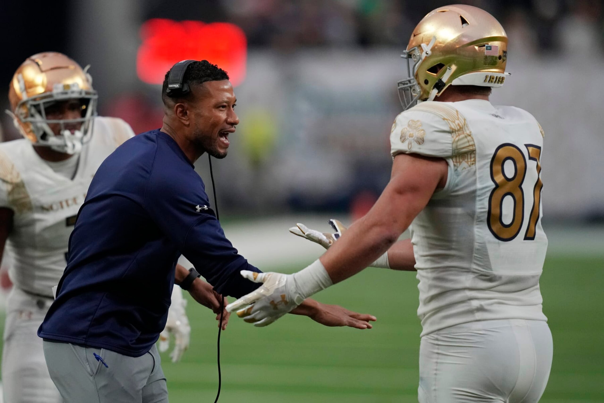 Notre Dame head coach Marcus Freeman, left, celebrates after Notre Dame tight end Michael Mayer (87) made a touchdown catch against BYU during the first half of an NCAA college football game Saturday, Oct. 8, 2022, in Las Vegas. (AP Photo/John Locher) Notre Dame head coach Marcus Freeman, left, celebrates after Notre Dame tight end Michael Mayer (87) made a touchdown catch against BYU during the first half of an NCAA college football game Saturday, Oct. 8, 2022, in Las Vegas. (AP Photo/John Locher)