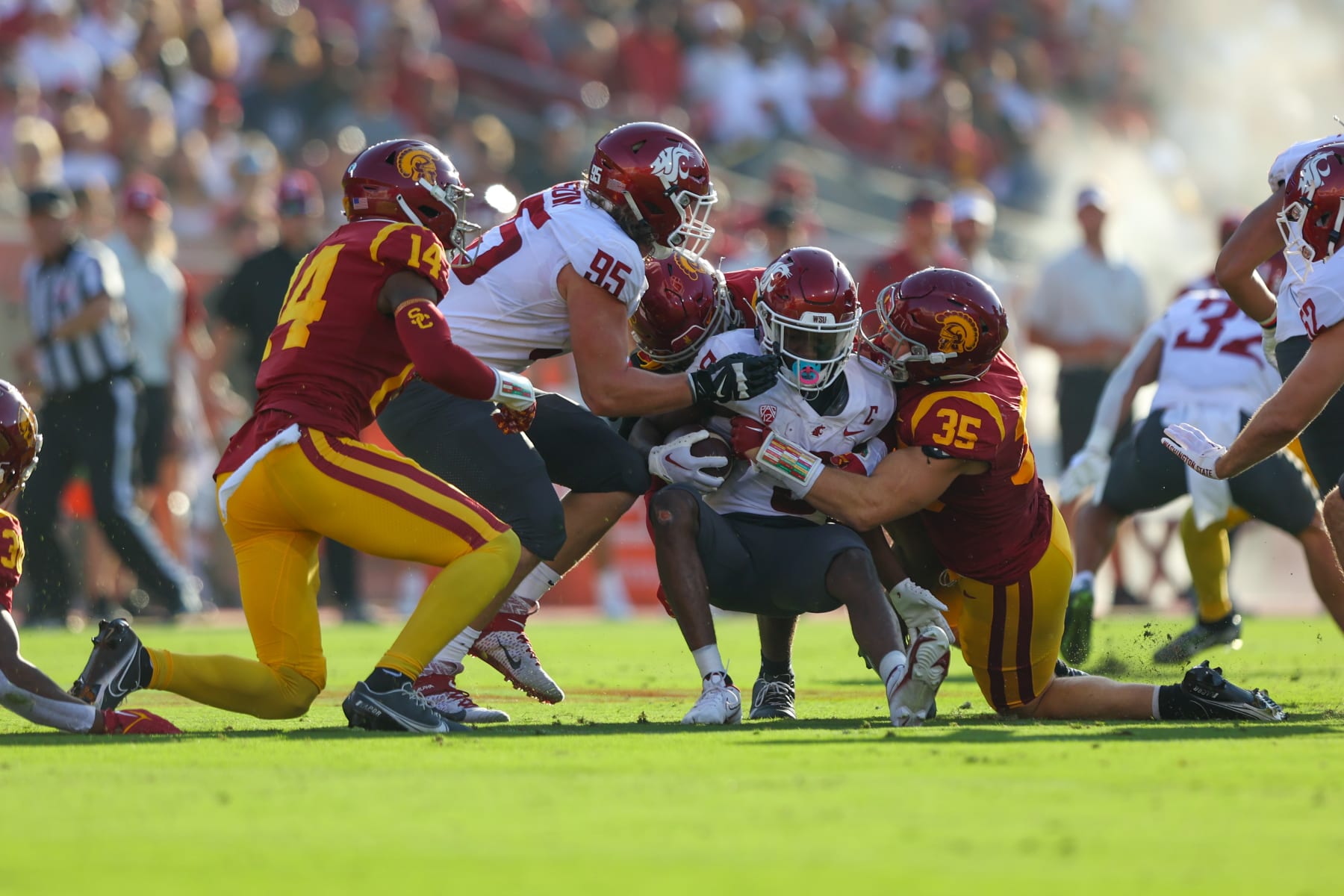 LOS ANGELES, CA - OCTOBER 08: Washington State Cougars wide receiver Lincoln Victor (5) gets tackled by USC Trojans linebacker Clyde Moore (35) and USC Trojans defensive back Jacobe Covington (14) during a college football game between the Washington State Cougars against the USC Trojans on October 08, 2022, at United Airlines Field at The Los Angeles Memorial Coliseum in Los Angeles, CA. (Photo by Jordon Kelly/Icon Sportswire via Getty Images)
