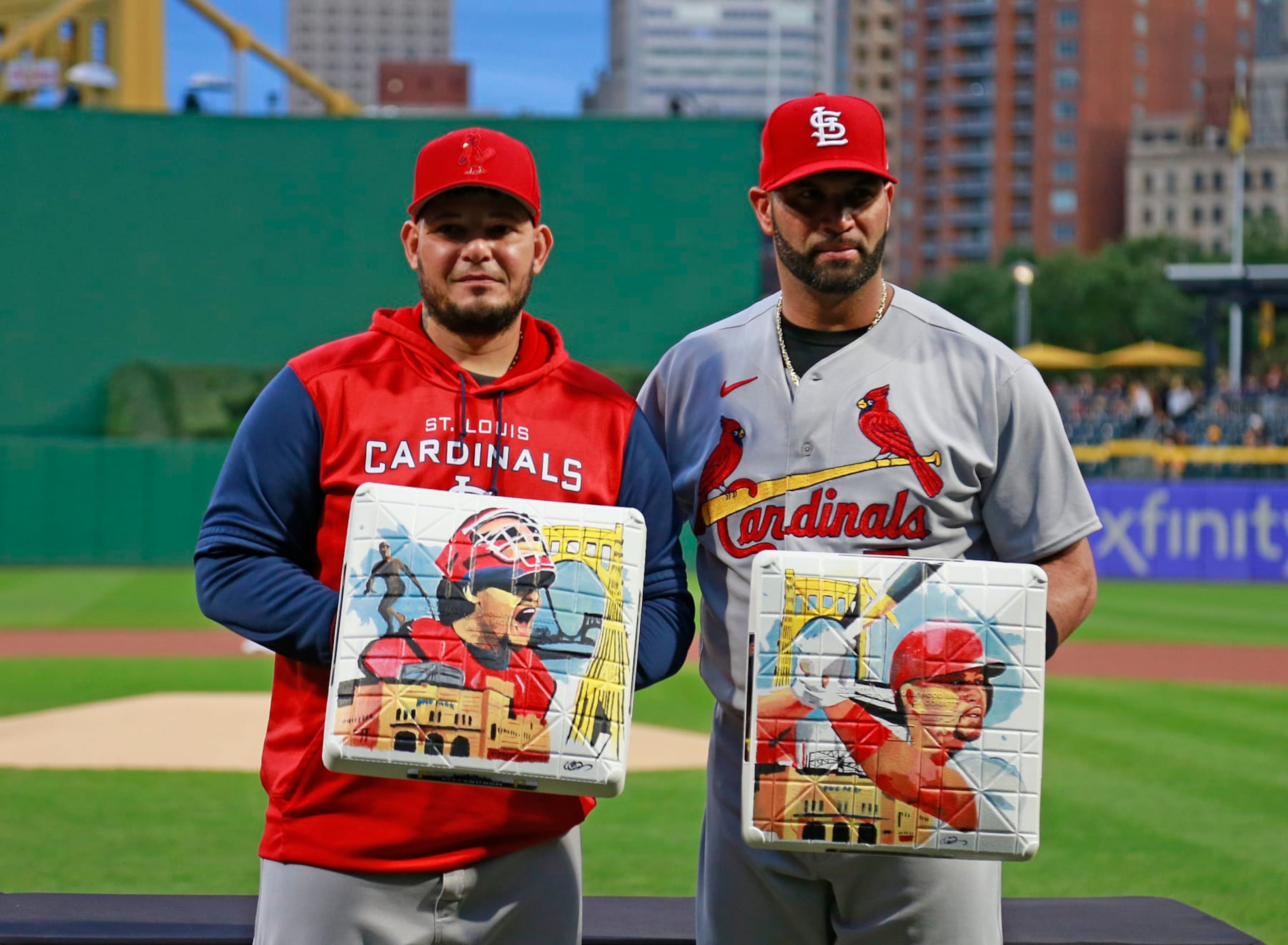PITTSBURGH, PA - OCTOBER 04: (L-R)  Yadier Molina #4 of the St. Louis Cardinals and Albert Pujols #5 of the St. Louis Cardinals receive commemorative bases from the Pittsburgh Pirates in honor of their upcoming retirement from baseball before the game between the St. Louis Cardinals and the Pittsburgh Pirates at PNC Park on October 4, 2022 in Pittsburgh, Pennsylvania.  (Photo by Justin K. Aller/Getty Images)
