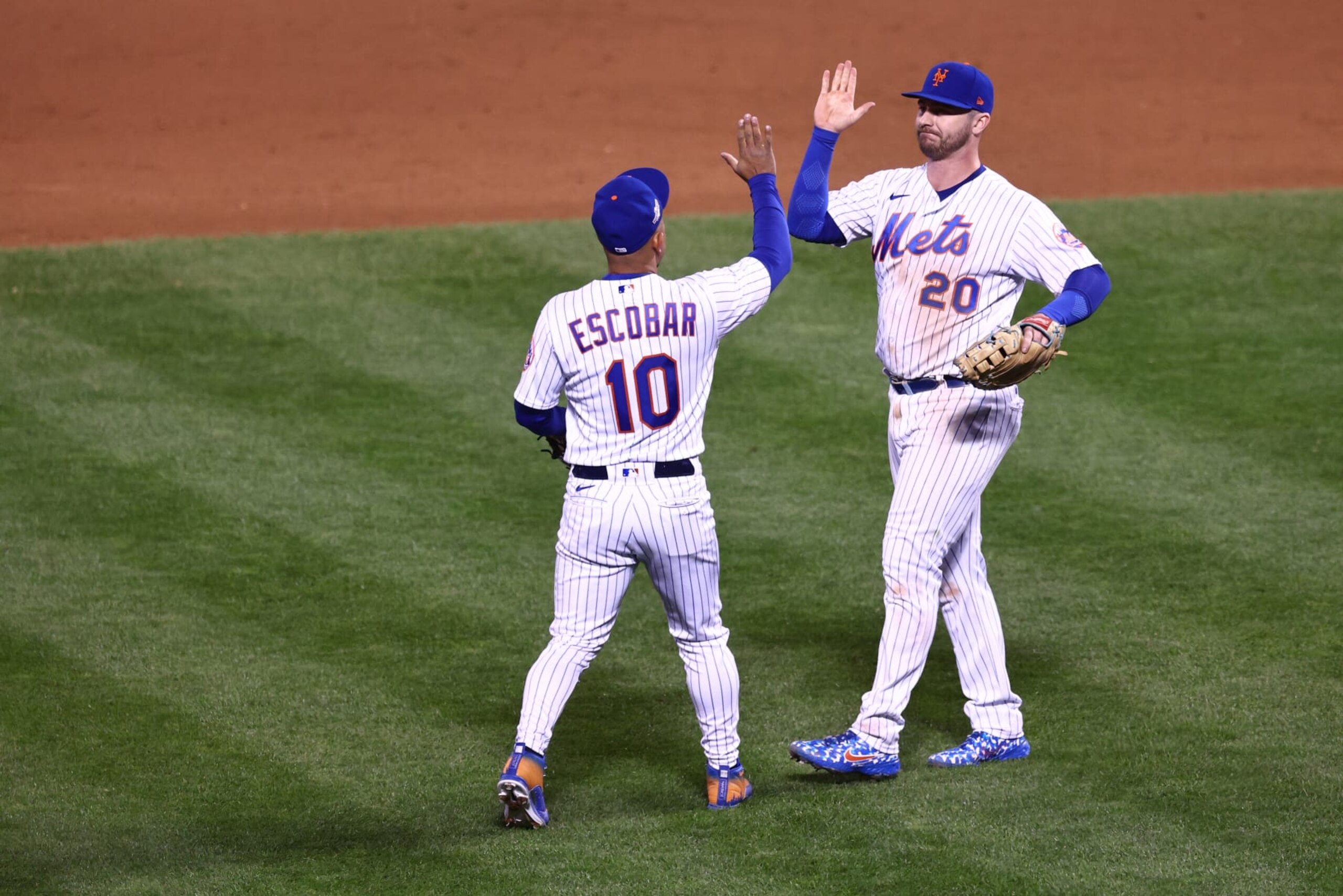 NEW YORK, NEW YORK - OCTOBER 08: Eduardo Escobar #10 of the New York Mets and Pete Alonso #20  celebrate defeating the San Diego Padres 7-3 in game two of the Wild Card Series at Citi Field on October 08, 2022 in New York City. (Photo by Dustin Satloff/Getty Images)