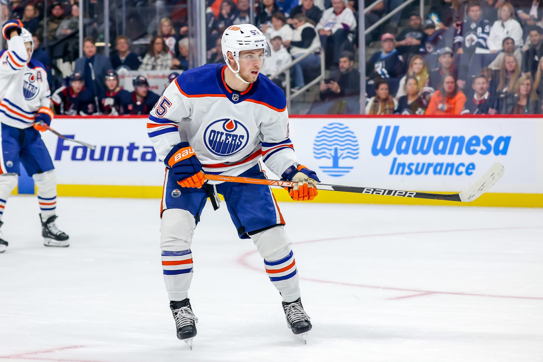 WINNIPEG, CANADA - OCTOBER 1: Dylan Holloway #55 of the Edmonton Oilers keeps an eye on the play during second period action against the Winnipeg Jets in pre-season action at the Canada Life Centre on October 1, 2022 in Winnipeg, Manitoba, Canada. (Photo by Jonathan Kozub/NHLI via Getty Images)