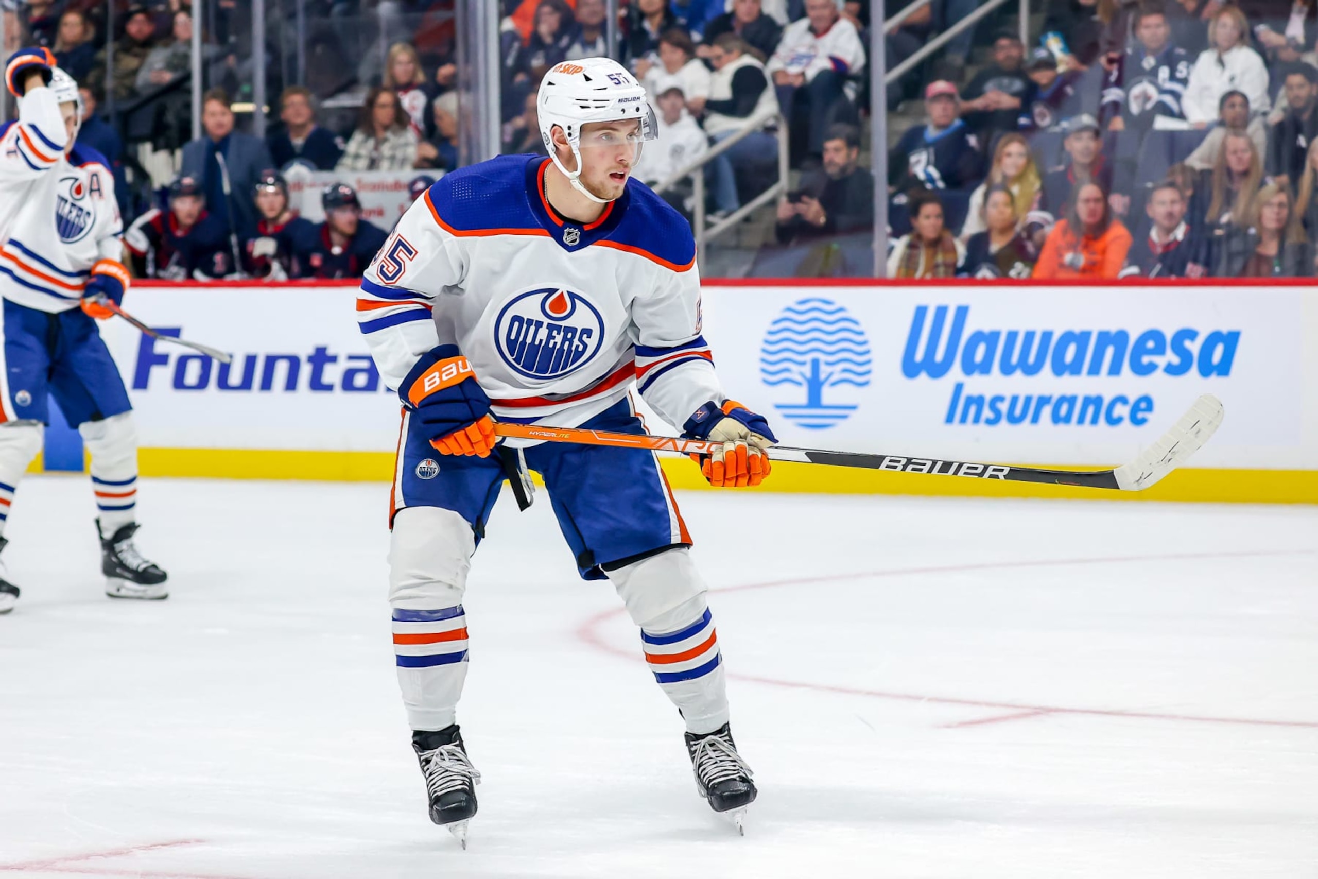WINNIPEG, CANADA - OCTOBER 1: Dylan Holloway #55 of the Edmonton Oilers keeps an eye on the play during second period action against the Winnipeg Jets in pre-season action at the Canada Life Centre on October 1, 2022 in Winnipeg, Manitoba, Canada. (Photo by Jonathan Kozub/NHLI via Getty Images)