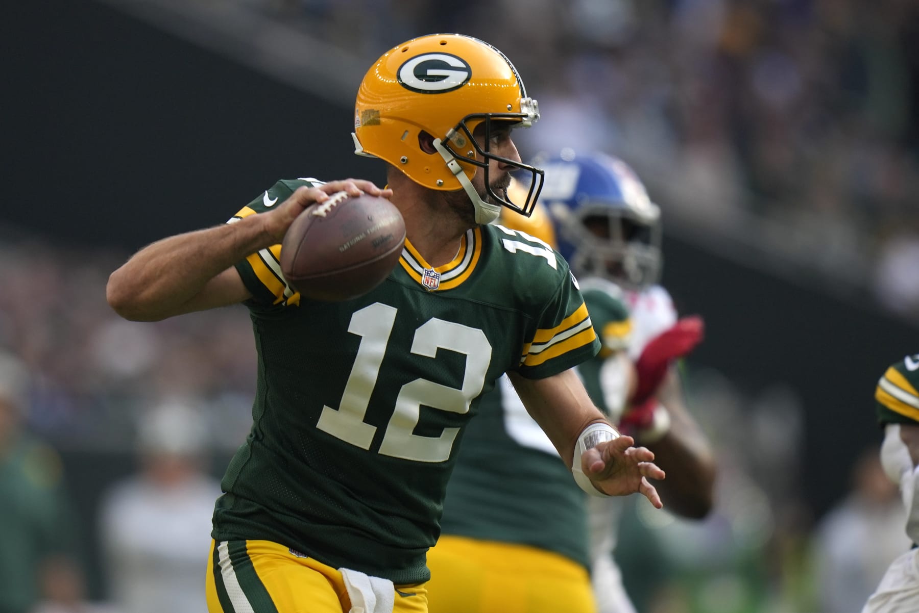 Green Bay Packers quarterback Aaron Rodgers (12) passes the ball during the first quarter of an NFL game between the New York Giants and the Green Bay Packers at the Tottenham Hotspur stadium in London, Sunday, Oct. 9, 2022. (AP Photo/Alastair Grant)