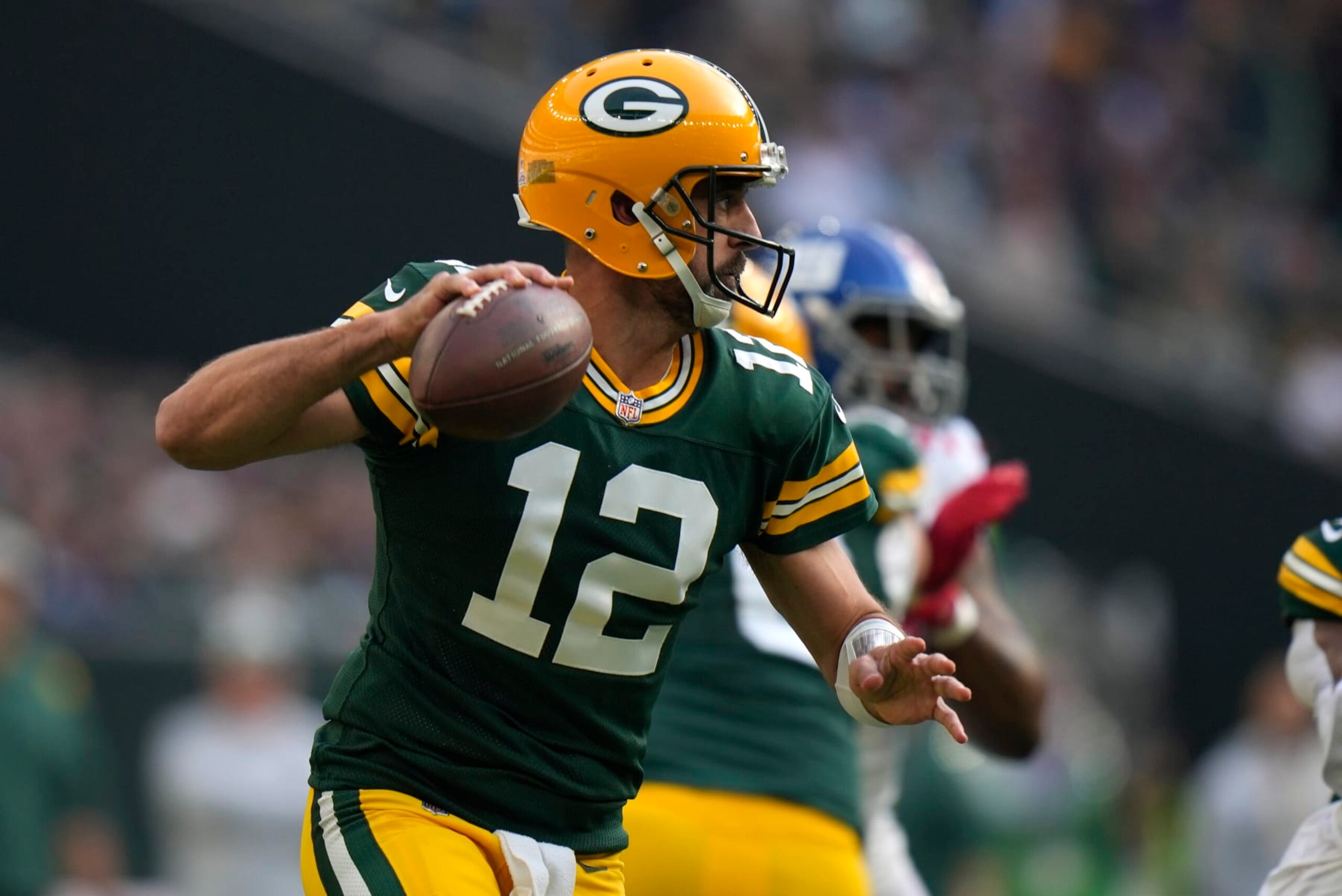 Green Bay Packers quarterback Aaron Rodgers (12) passes the ball during the first quarter of an NFL game between the New York Giants and the Green Bay Packers at the Tottenham Hotspur stadium in London, Sunday, Oct. 9, 2022. (AP Photo/Alastair Grant)