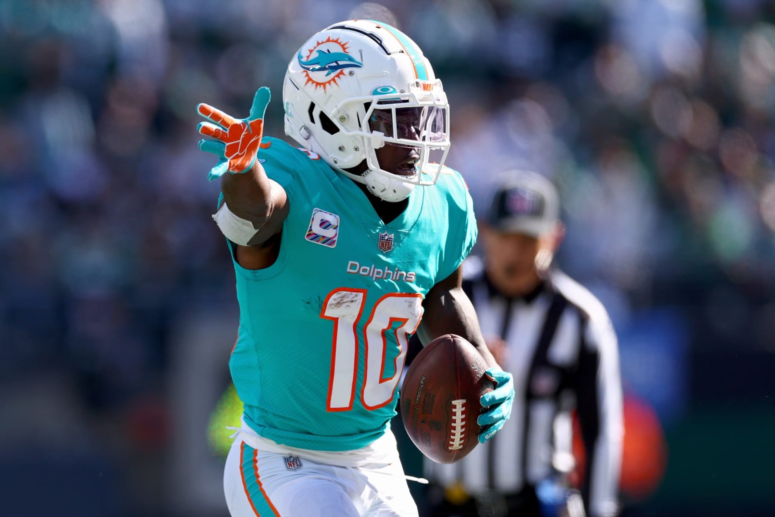 EAST RUTHERFORD, NEW JERSEY - OCTOBER 09: Tyreek Hill #10 of the Miami Dolphins celebrates a first down New York Jets during the second quarter at MetLife Stadium on October 09, 2022 in East Rutherford, New Jersey. (Photo by Elsa/Getty Images)