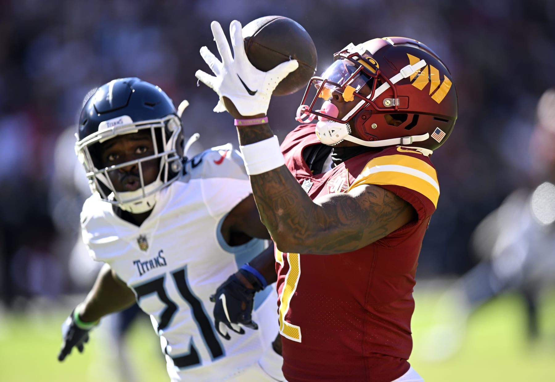 LANDOVER, MARYLAND - OCTOBER 09: Dyami Brown #2 of the Washington Commanders catches a touchdown over Roger McCreary #21 of the Tennessee Titans during the third quarter at FedExField on October 09, 2022 in Landover, Maryland. (Photo by Greg Fiume/Getty Images)