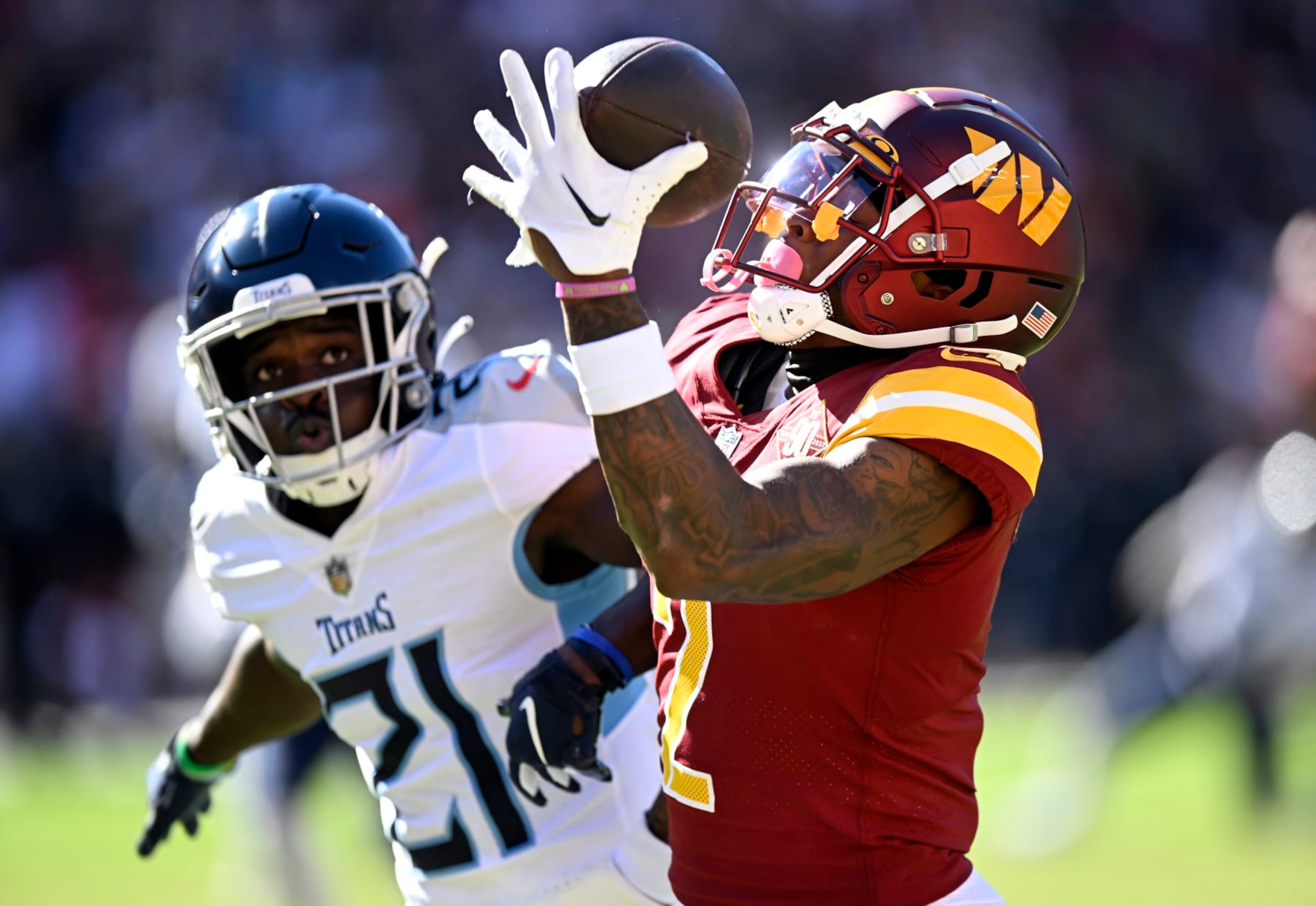 LANDOVER, MARYLAND - OCTOBER 09: Dyami Brown #2 of the Washington Commanders catches a touchdown over Roger McCreary #21 of the Tennessee Titans during the third quarter at FedExField on October 09, 2022 in Landover, Maryland. (Photo by Greg Fiume/Getty Images)