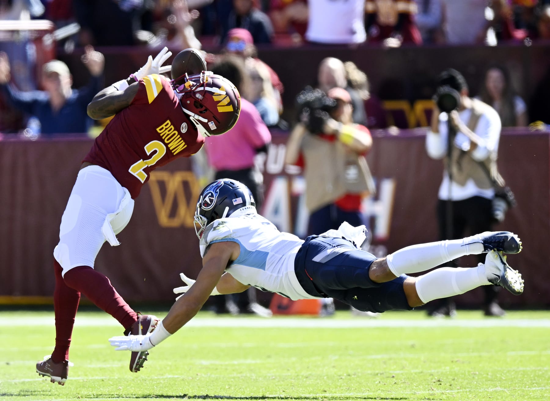 LANDOVER, MARYLAND - OCTOBER 09: Dyami Brown #2 of the Washington Commanders catches a touchdown pass over Caleb Farley #3 of the Tennessee Titans during the second quarter at FedExField on October 09, 2022 in Landover, Maryland. (Photo by Greg Fiume/Getty Images)